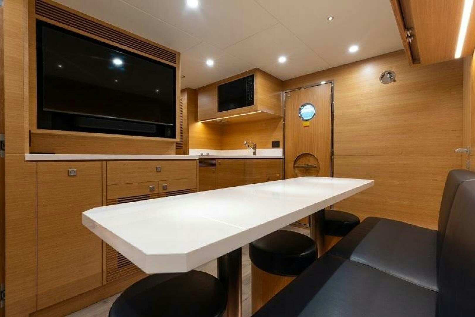 a room with a table and chairs aboard WIGGLE ROOM Yacht for Sale