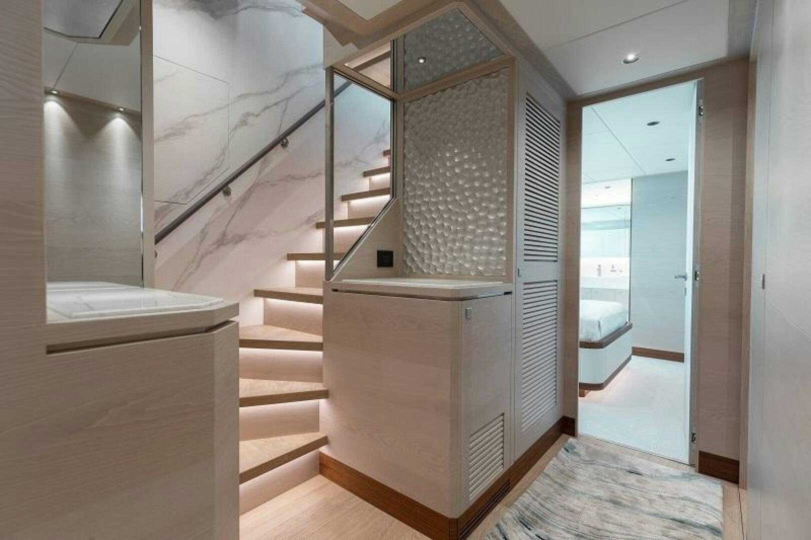 a room with a staircase and a glass door aboard WIGGLE ROOM Yacht for Sale