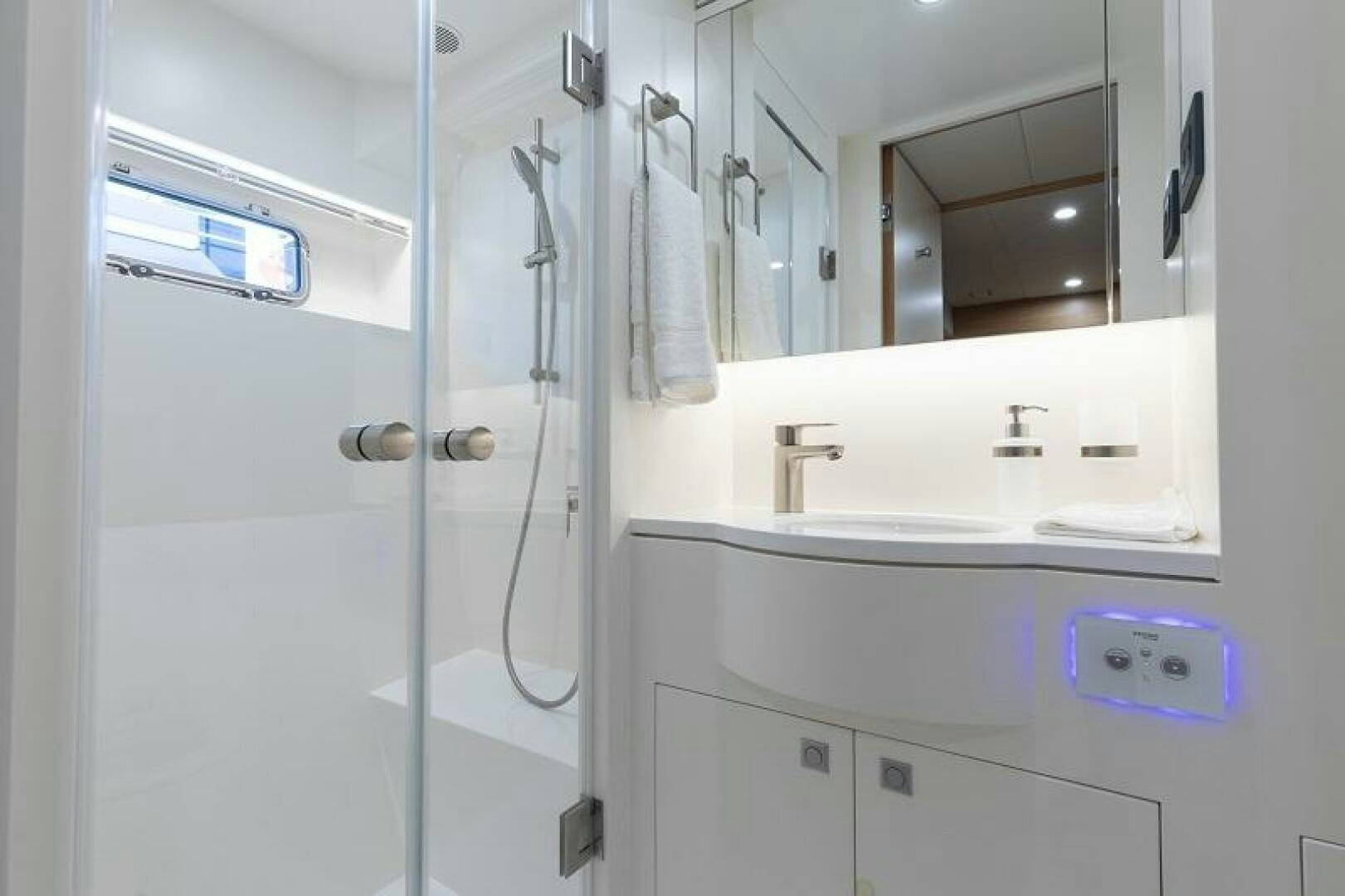 a bathroom with a glass shower aboard WIGGLE ROOM Yacht for Sale