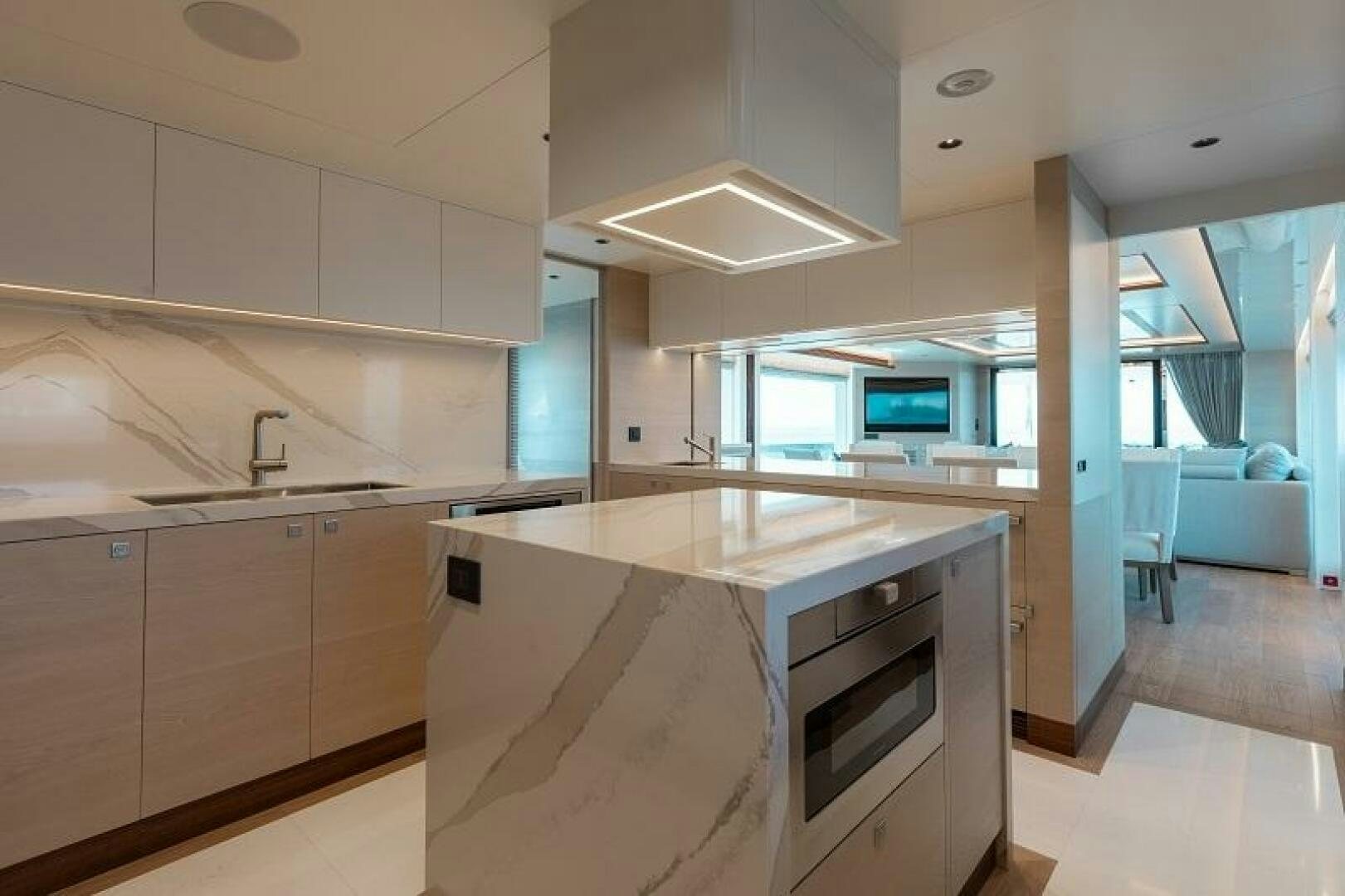 a kitchen with white cabinets aboard WIGGLE ROOM Yacht for Sale