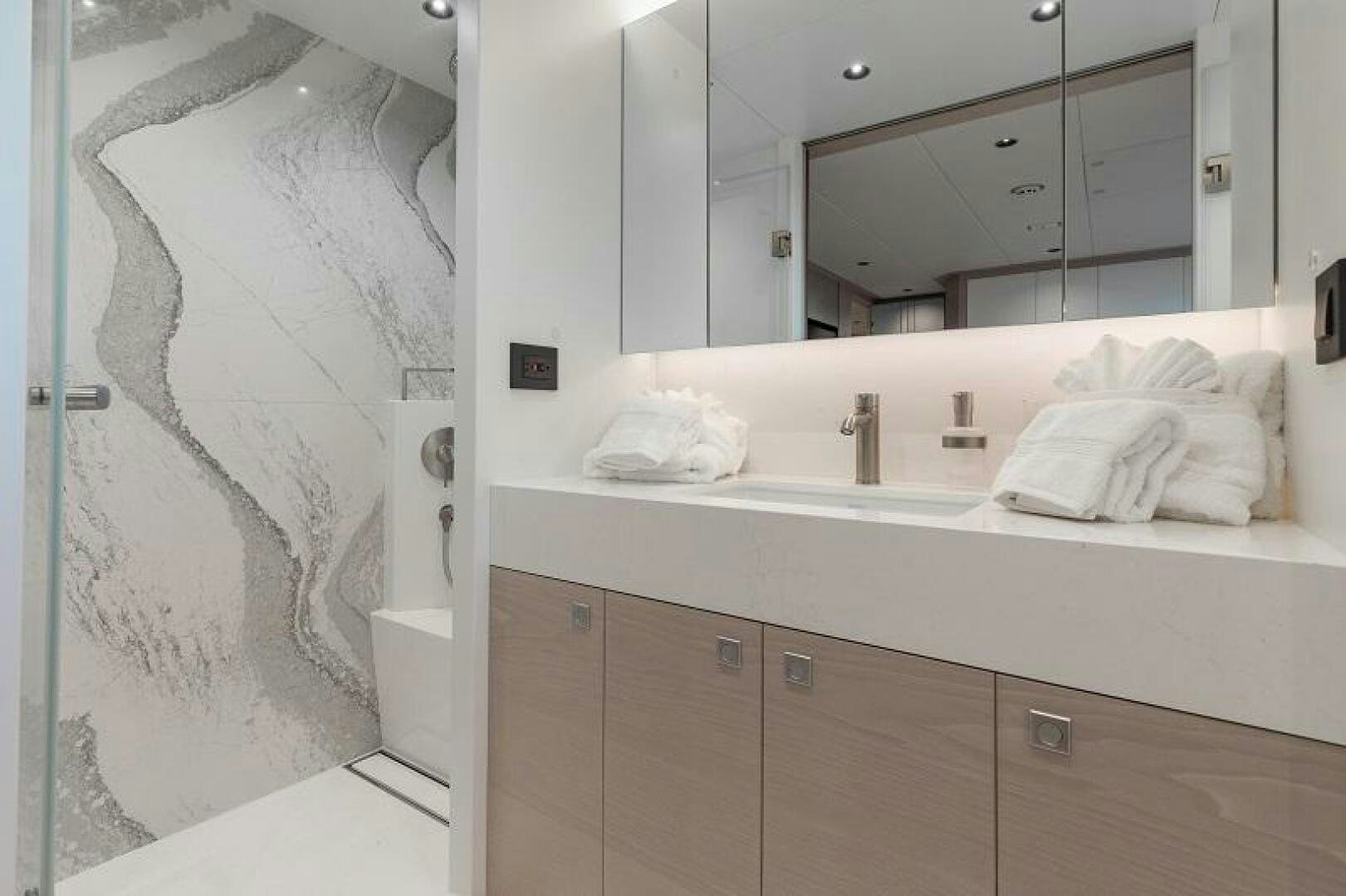 a bathroom with a large mirror aboard WIGGLE ROOM Yacht for Sale