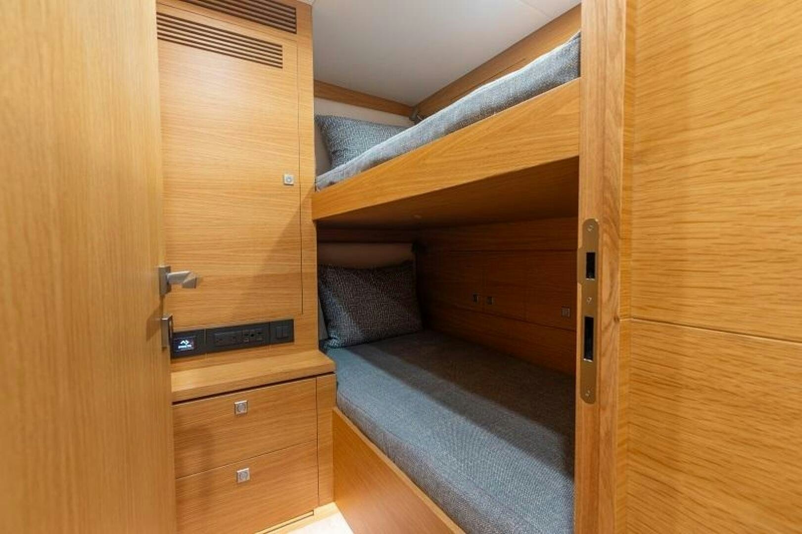 a wooden bunk bed aboard WIGGLE ROOM Yacht for Sale