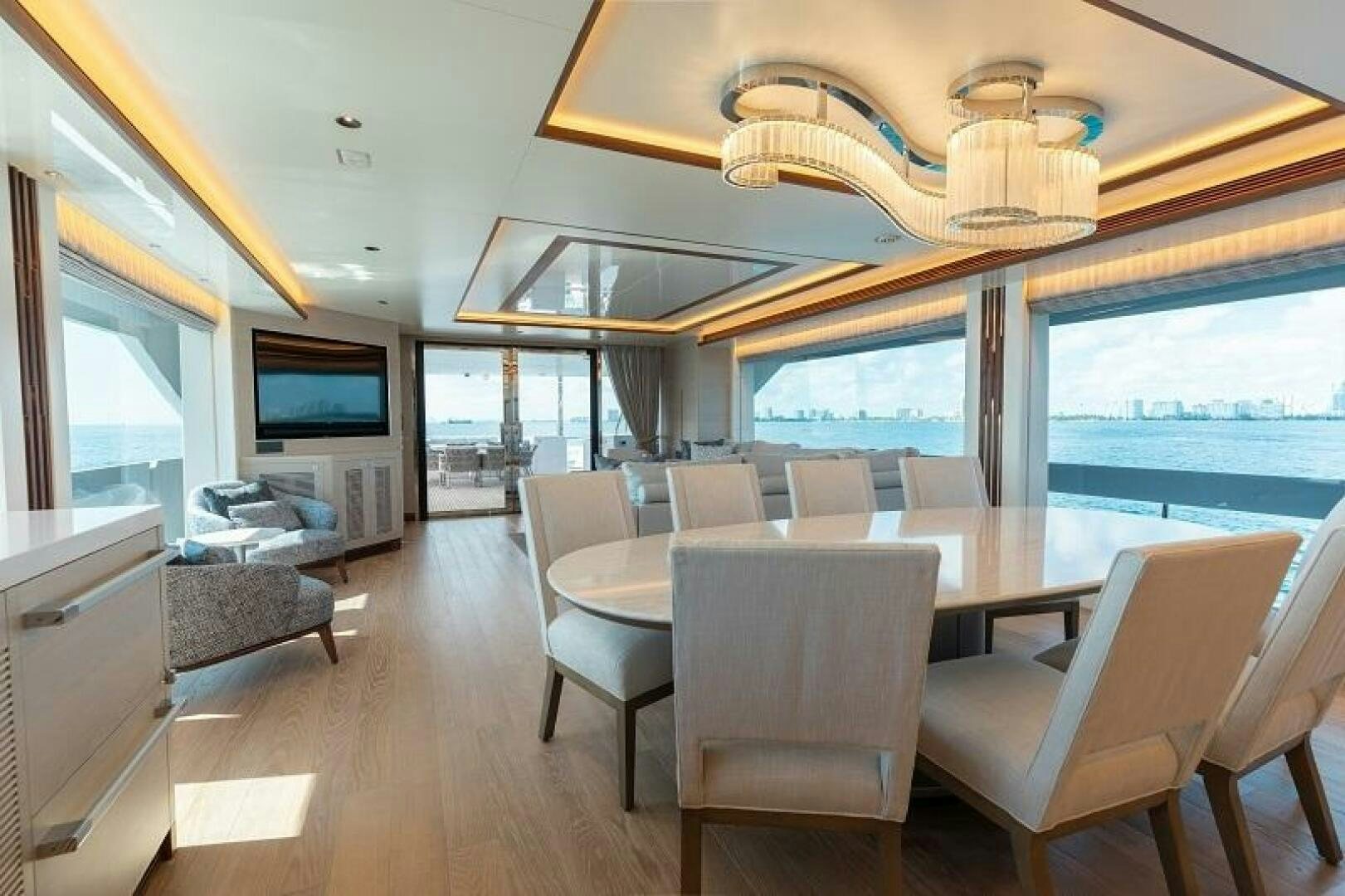 a large dining room with a large chandelier aboard WIGGLE ROOM Yacht for Sale