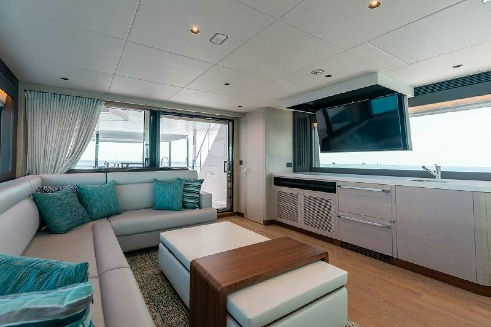 a living room with a couch and a television aboard WIGGLE ROOM Yacht for Sale