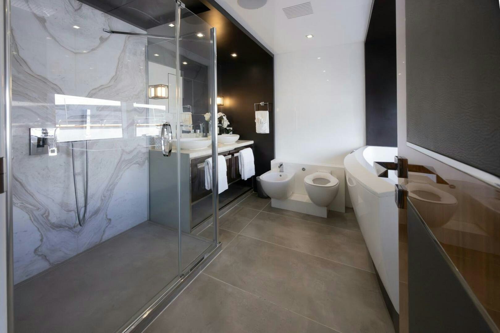 a bathroom with a glass shower aboard LADY CAROLINE Yacht for Sale