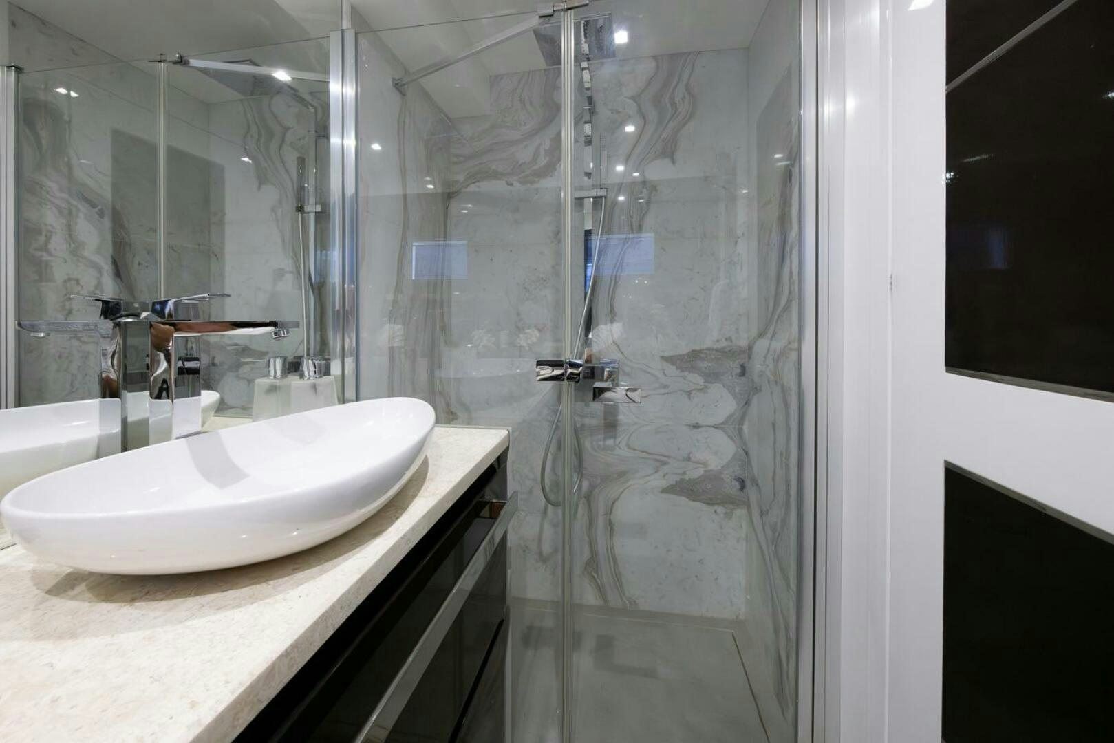 a bathroom with a glass shower aboard LADY CAROLINE Yacht for Sale
