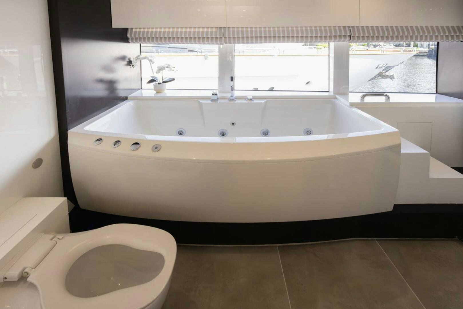a bathroom with a tub sink and toilet aboard LADY CAROLINE Yacht for Sale