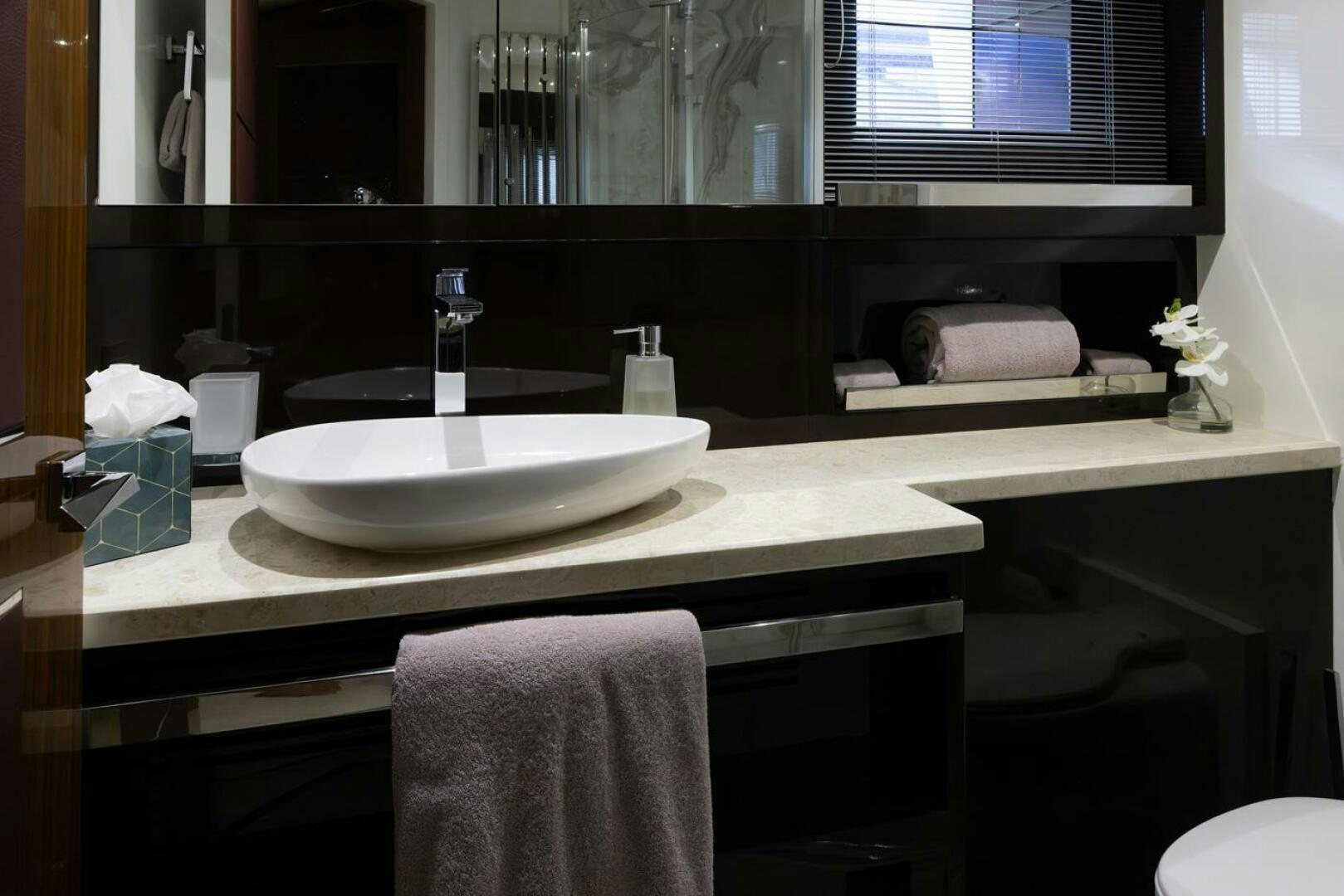 a bathroom with a sink and a mirror aboard LADY CAROLINE Yacht for Sale