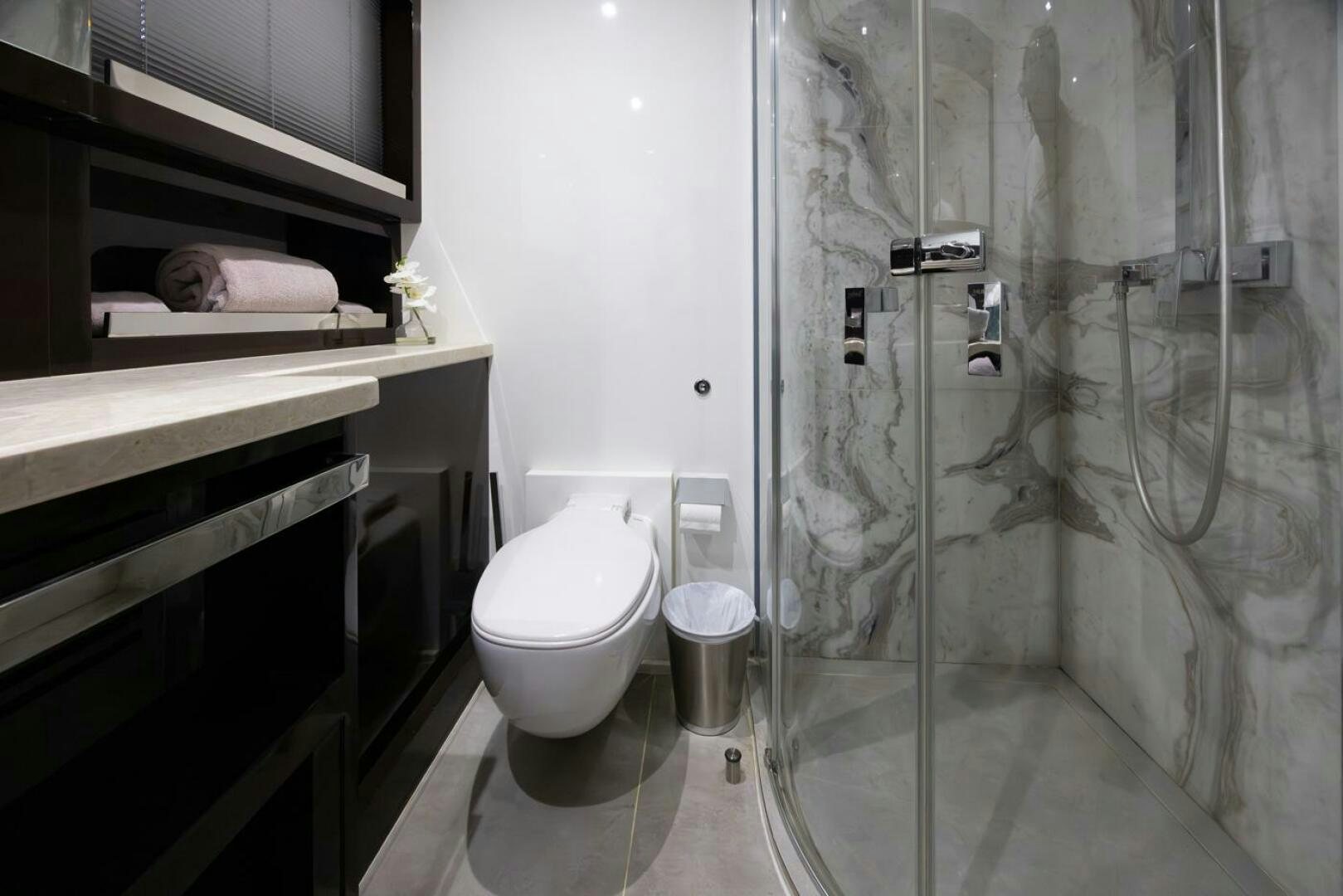 a bathroom with a glass shower aboard LADY CAROLINE Yacht for Sale