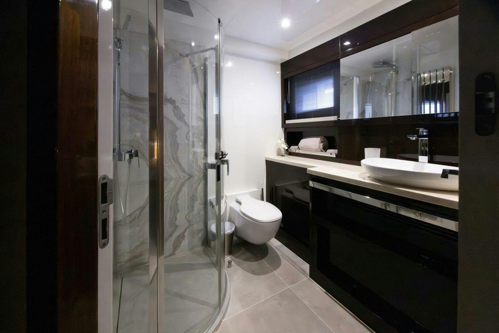a bathroom with a glass shower aboard LADY CAROLINE Yacht for Sale