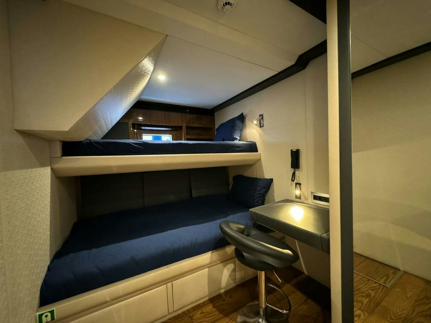 a bed with a desk and a chair aboard LADY CAROLINE Yacht for Sale