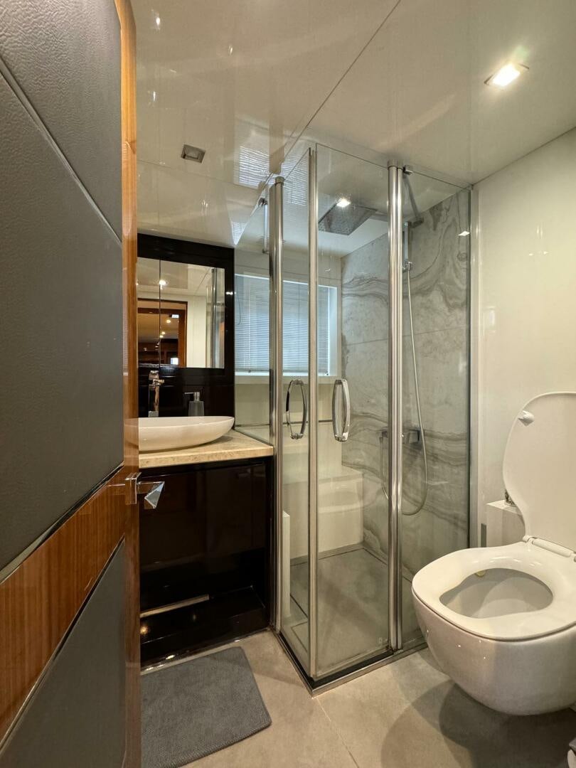 a bathroom with a glass shower aboard LADY CAROLINE Yacht for Sale