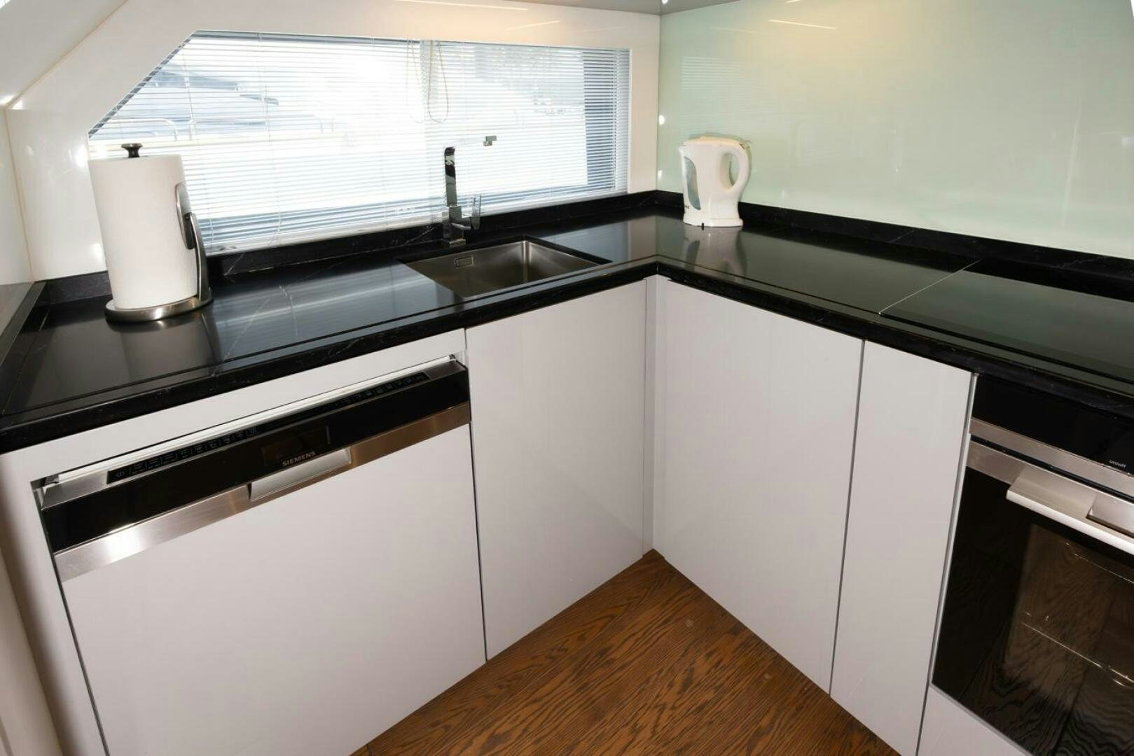 a kitchen with a sink and a window aboard LADY CAROLINE Yacht for Sale