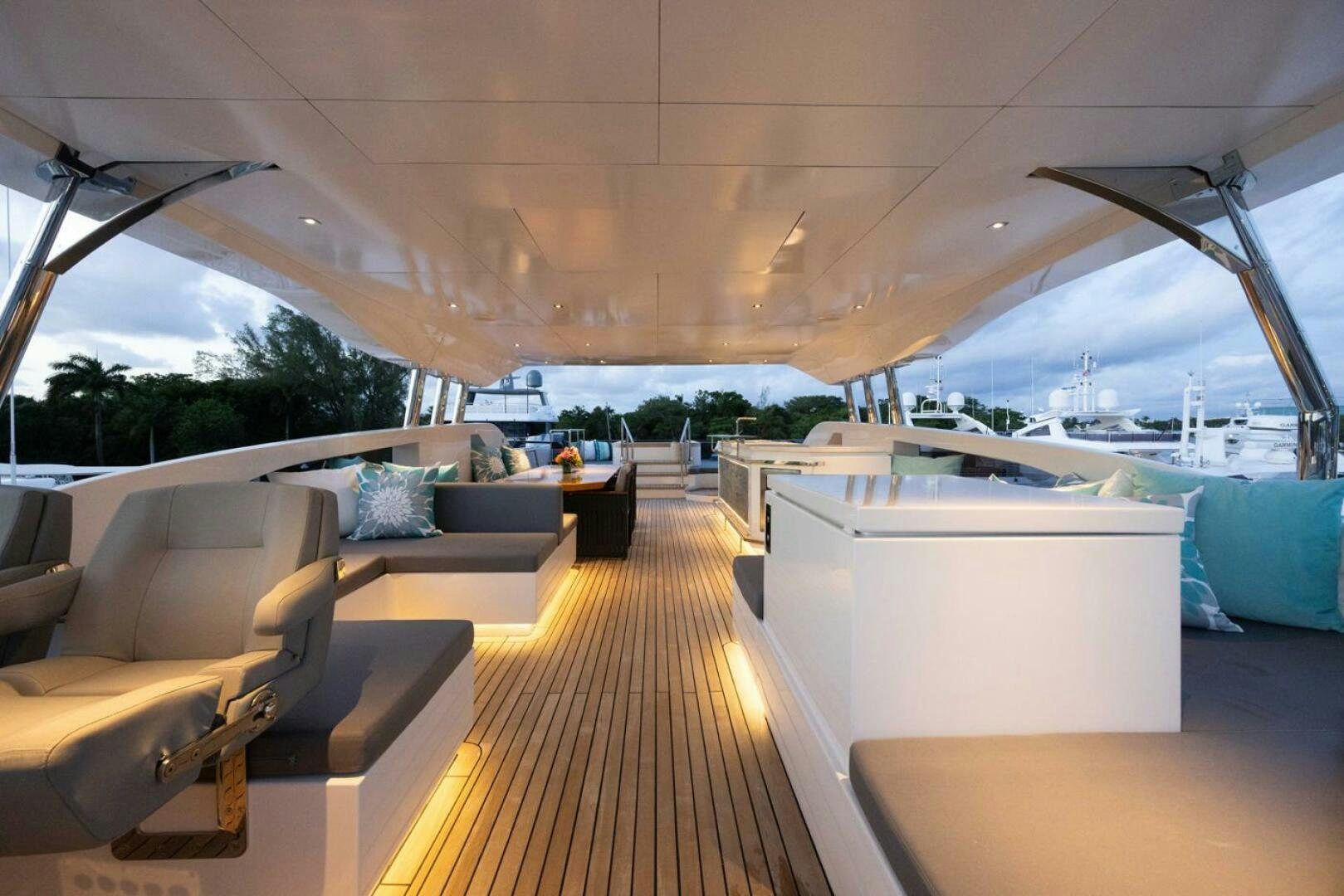 a room with a deck and a view of the water aboard LADY CAROLINE Yacht for Sale