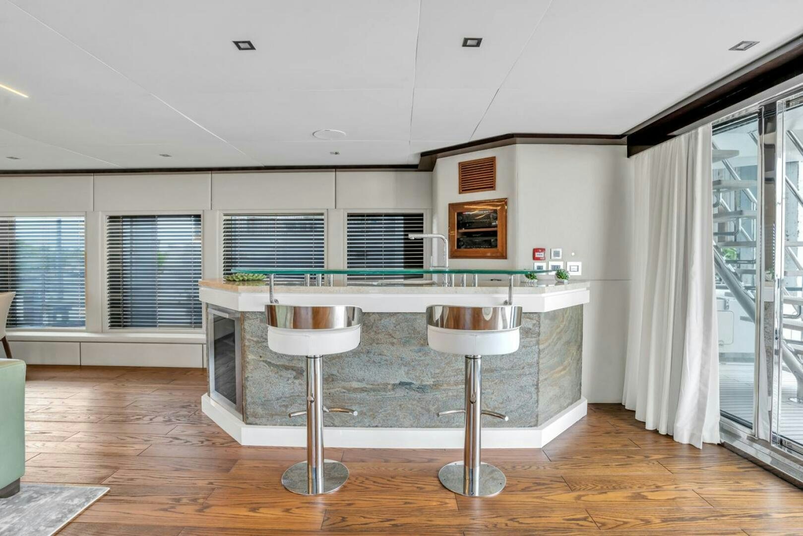 a kitchen with a table and stools aboard LADY CAROLINE Yacht for Sale
