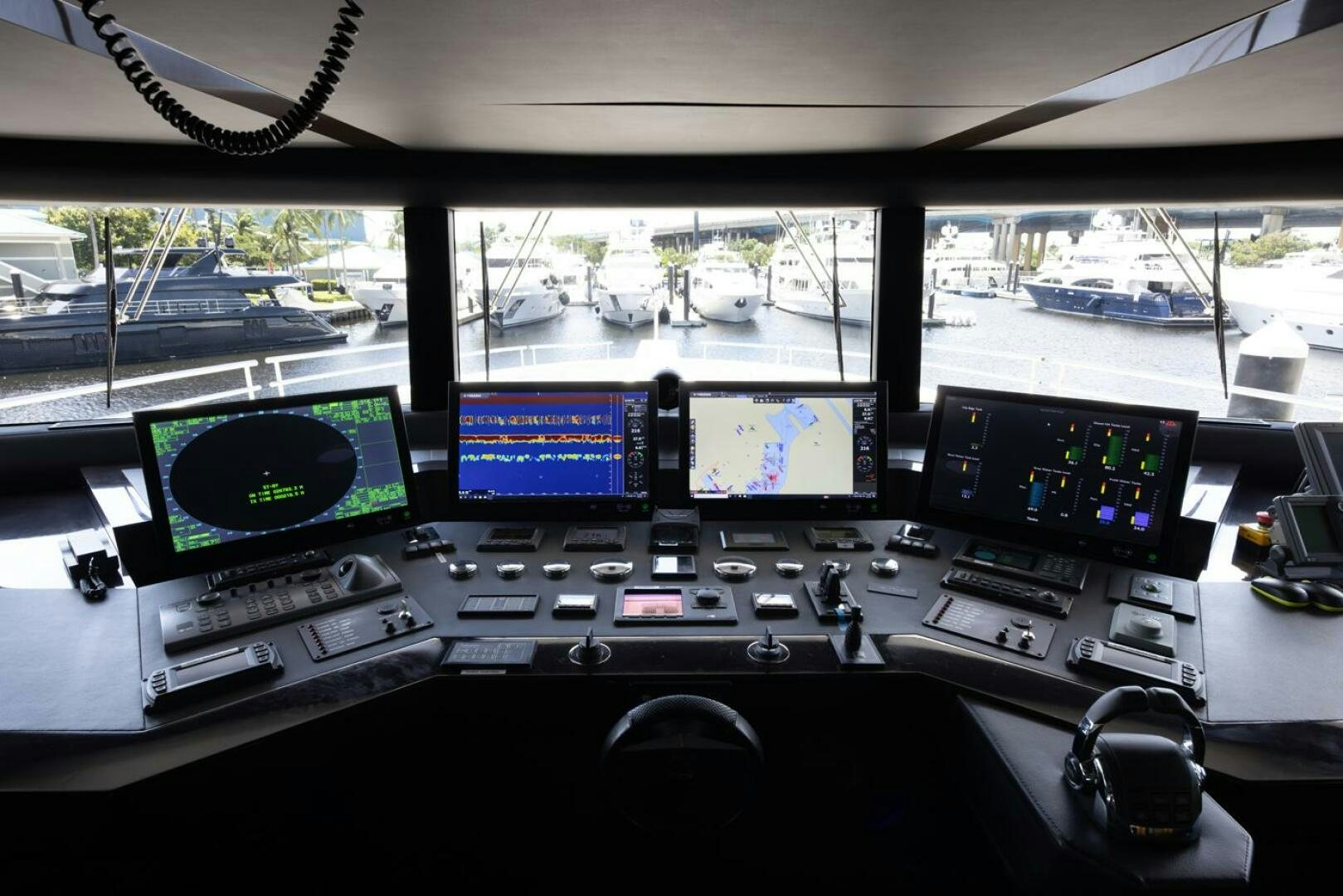 a control panel with multiple monitors aboard LADY CAROLINE Yacht for Sale