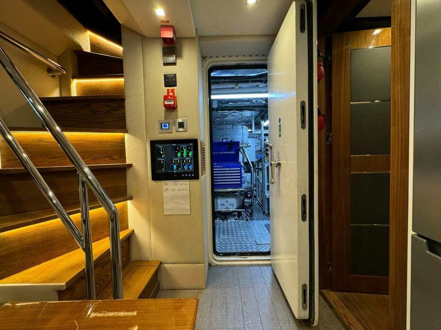 a hallway with a door and a machine on the wall aboard LADY CAROLINE Yacht for Sale