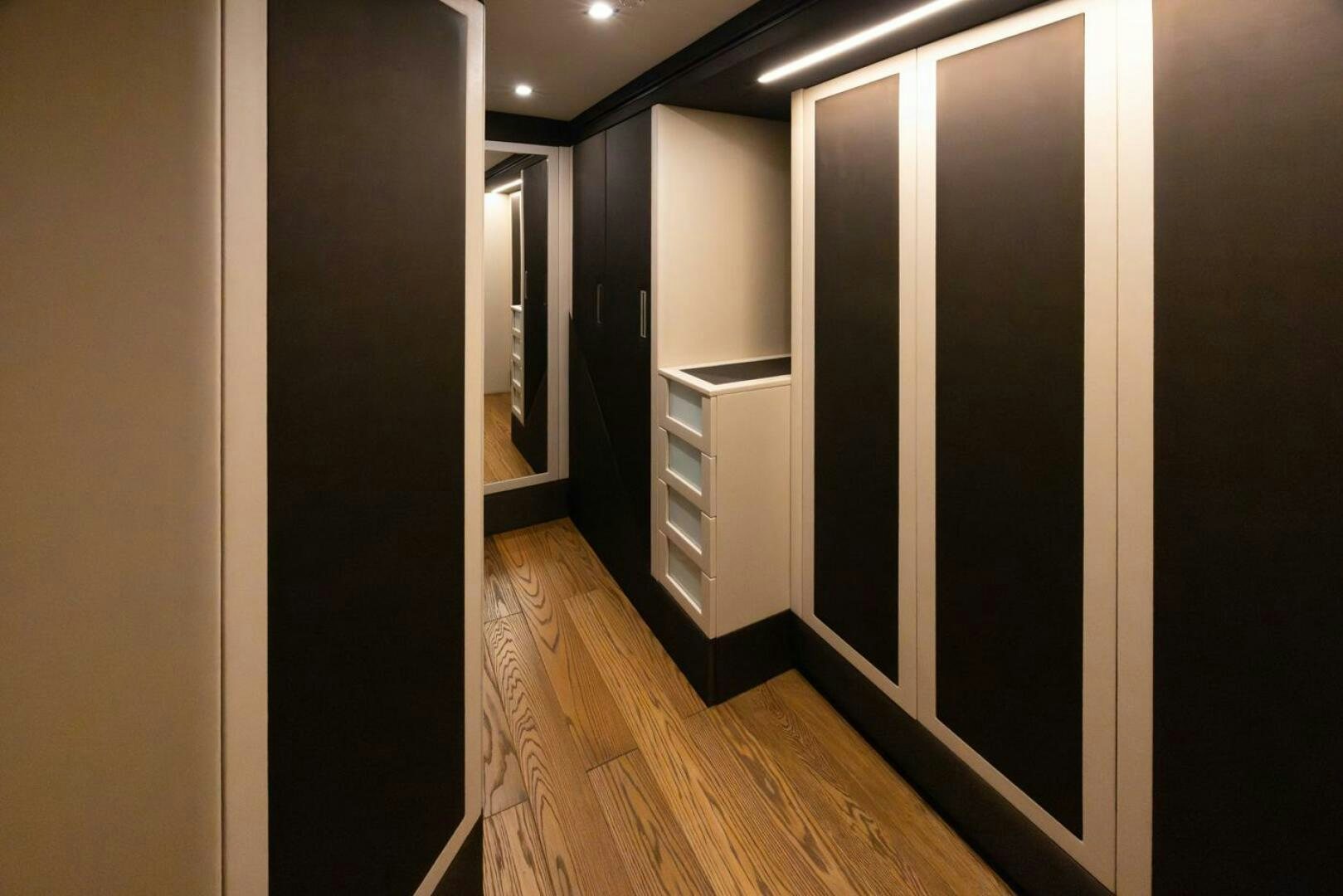 a hallway with a wood floor and cabinets aboard LADY CAROLINE Yacht for Sale