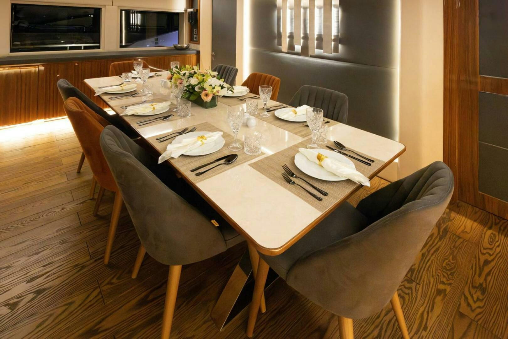 a table with plates and silverware aboard LADY CAROLINE Yacht for Sale