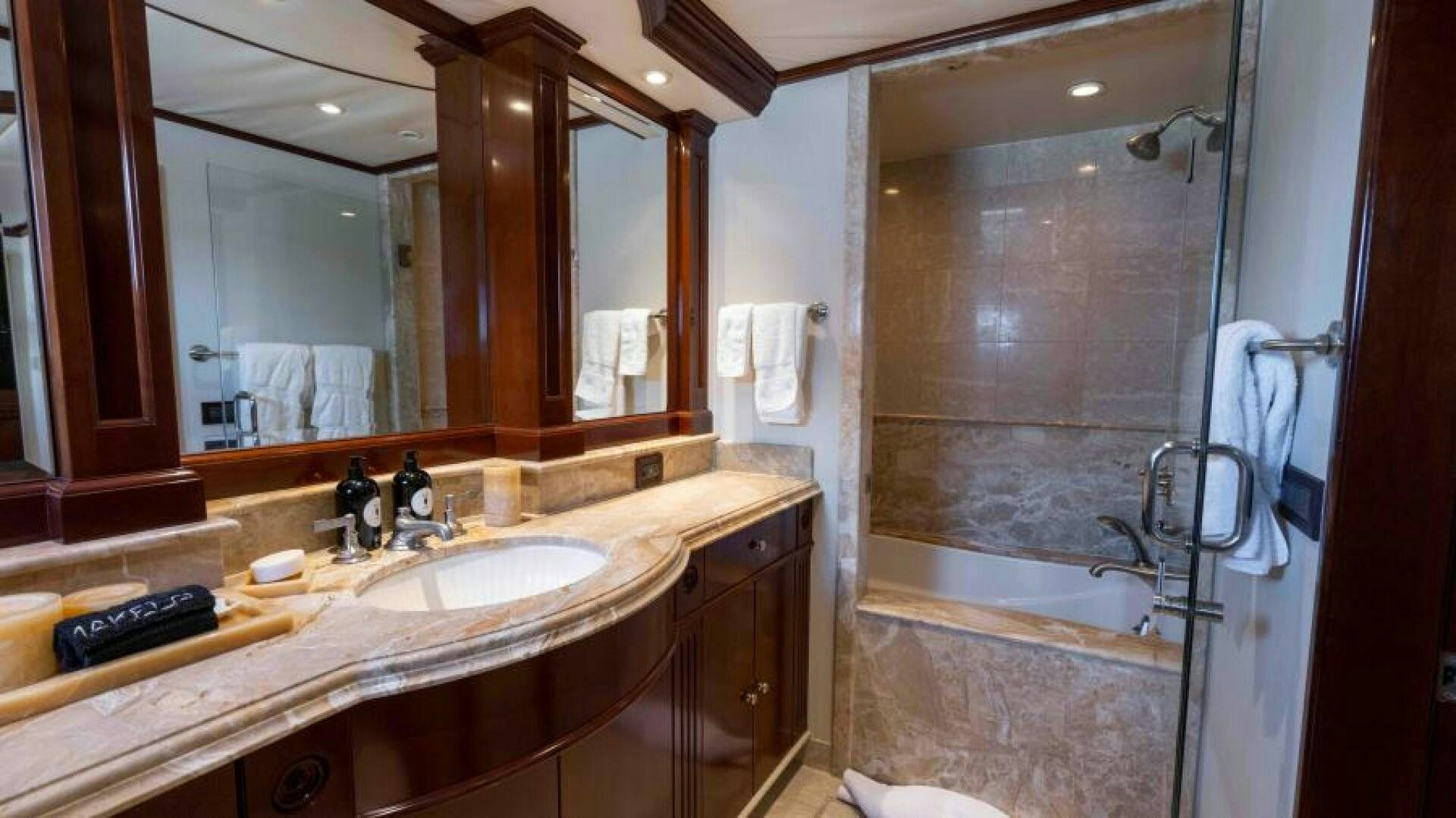 a bathroom with a large mirror aboard ODIN Yacht for Sale