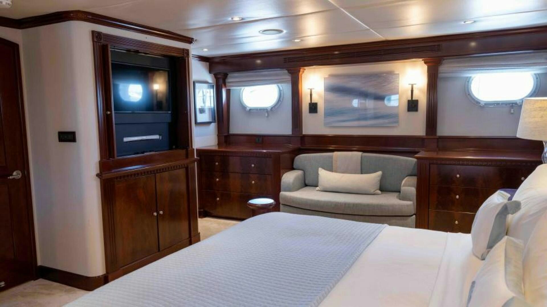 a hotel room with a bed and a television aboard ODIN Yacht for Sale