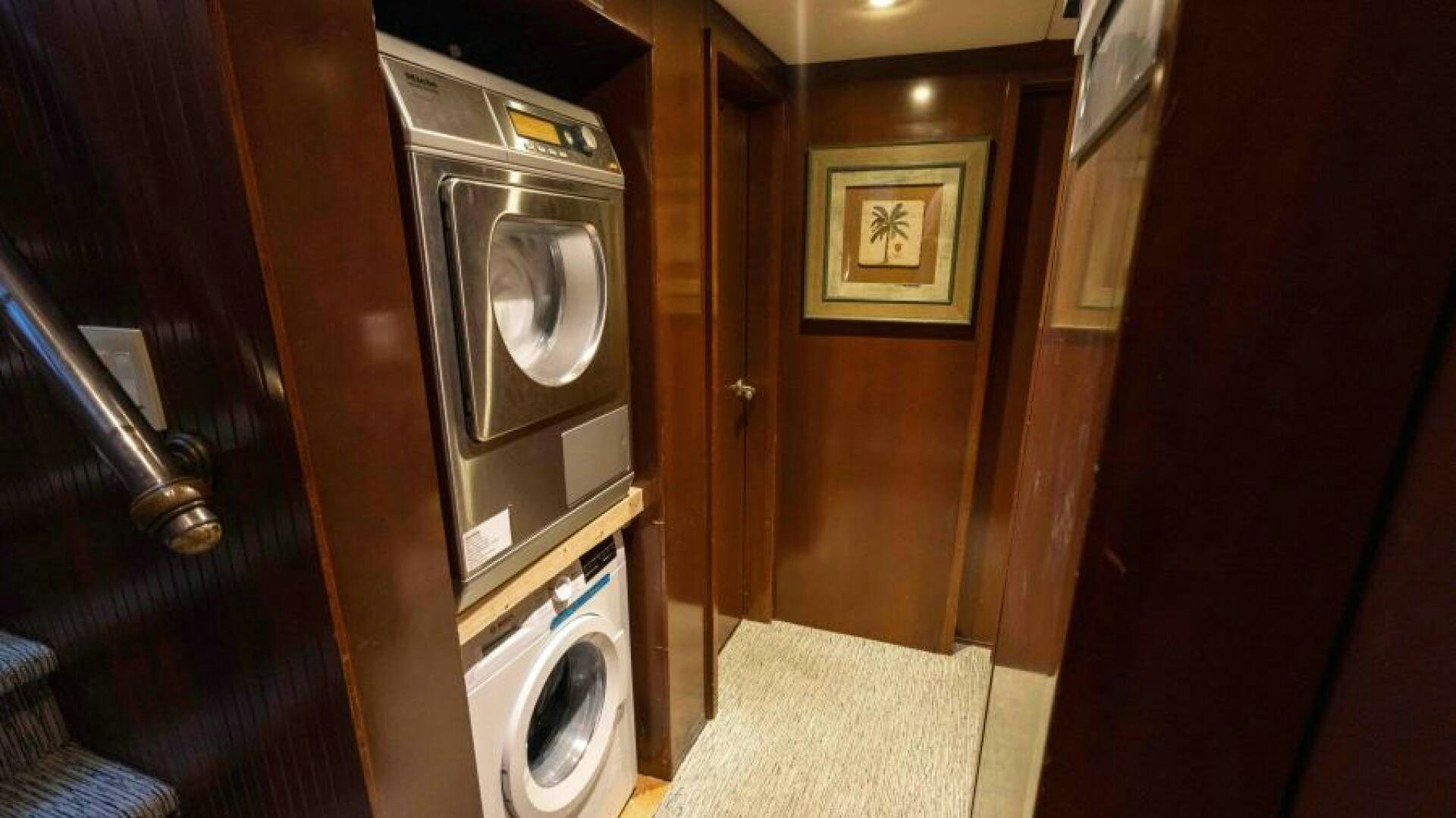a room with a washing machine and a door aboard ODIN Yacht for Sale