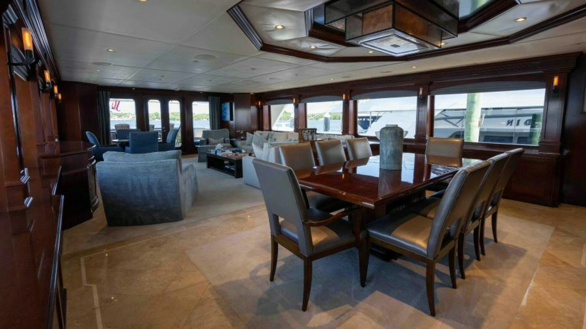 a large room with a table and chairs aboard ODIN Yacht for Sale