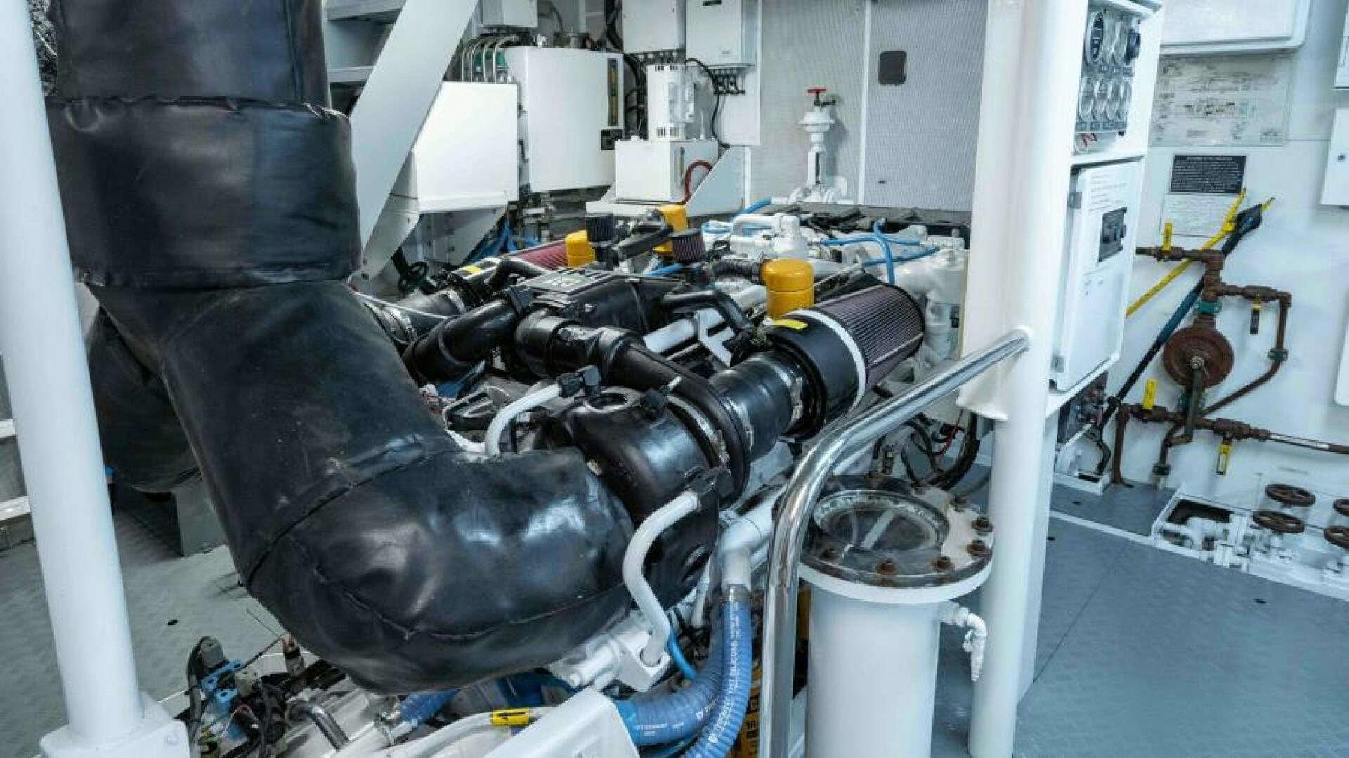 a black gloved hand holding a tool in a lab aboard ODIN Yacht for Sale
