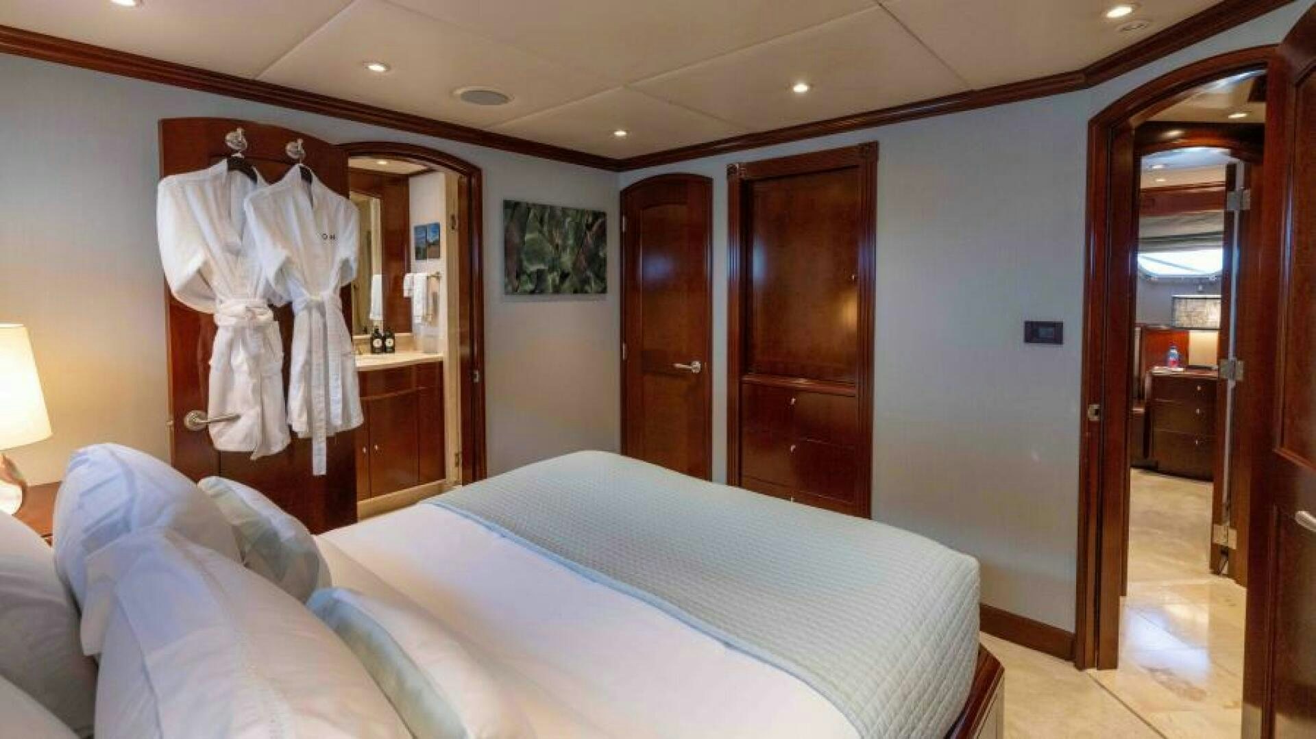 a bedroom with a bed and closet aboard ODIN Yacht for Sale