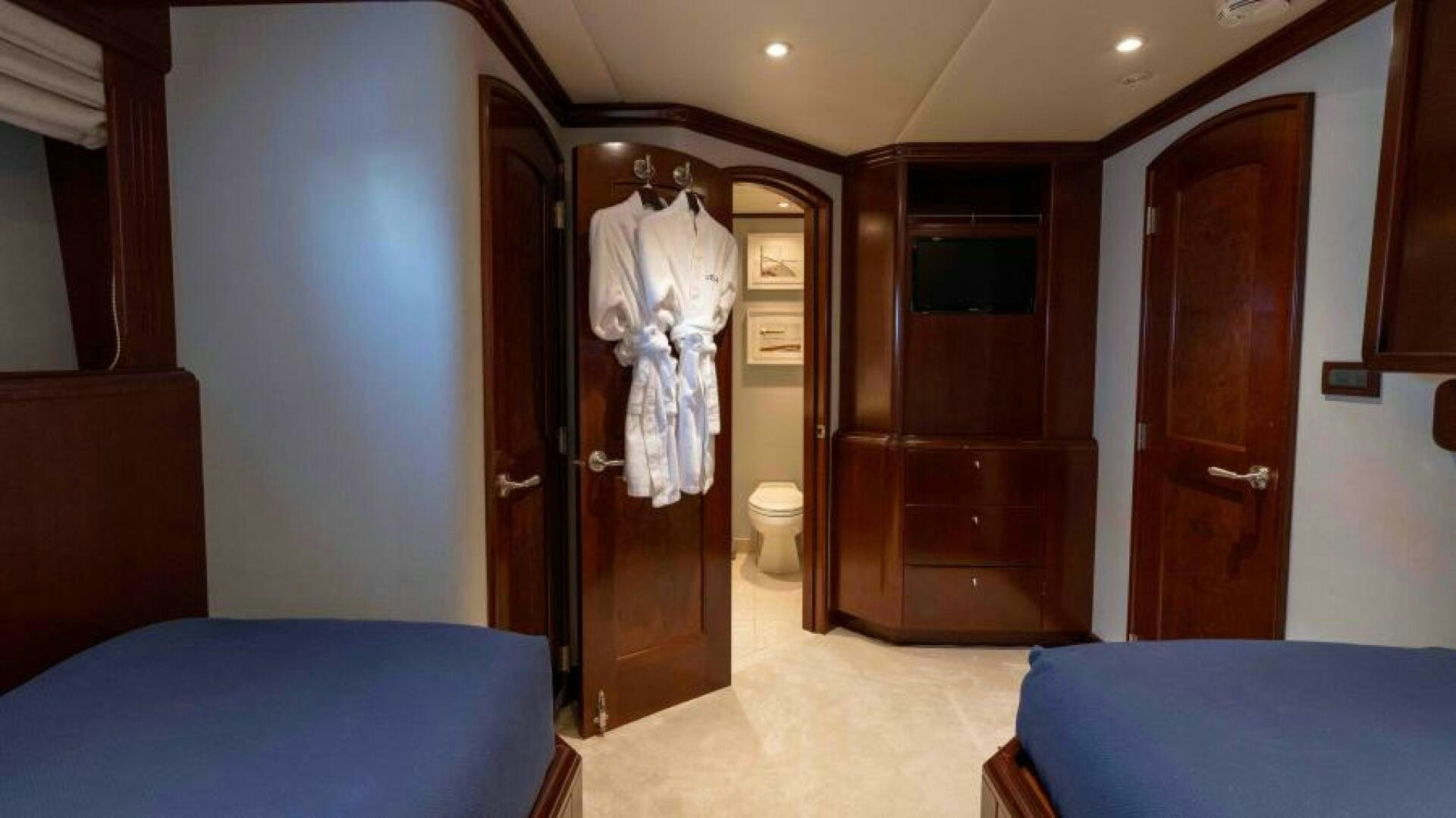a room with a bed and a closet aboard ODIN Yacht for Sale