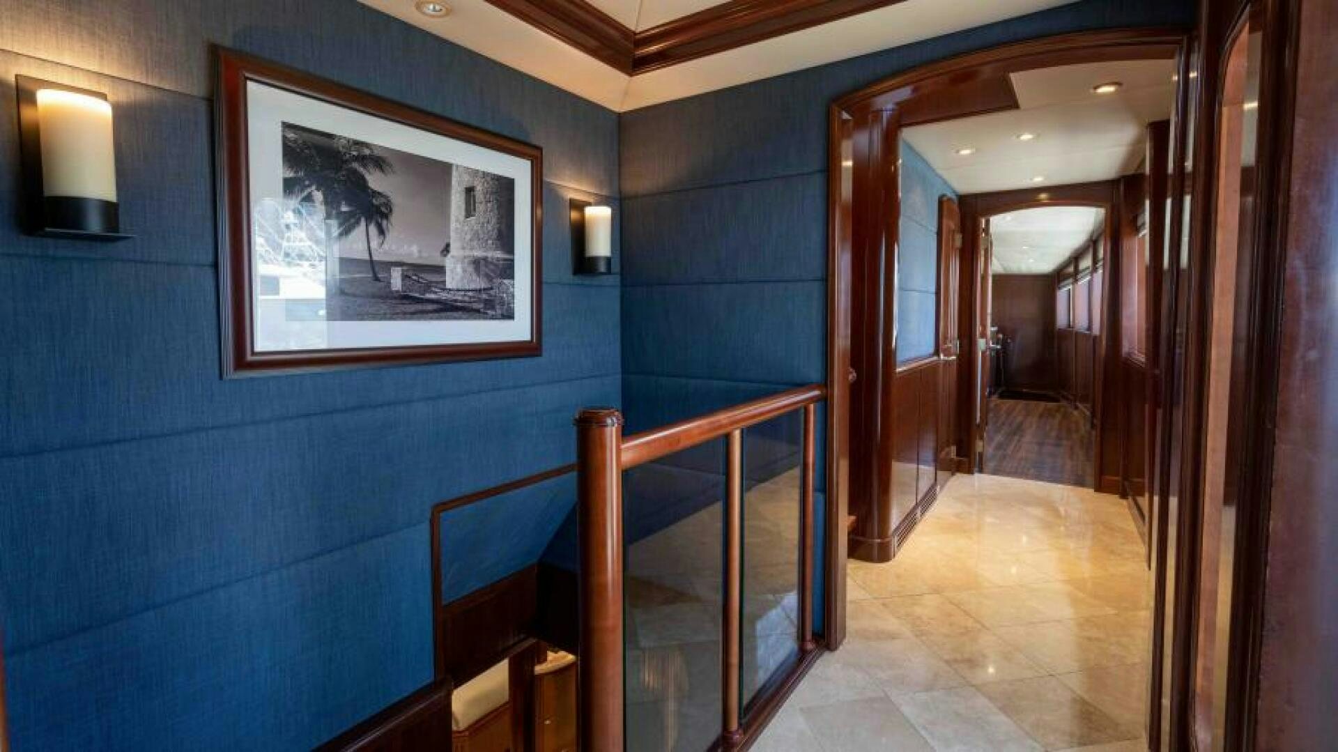 a hallway with blue walls aboard ODIN Yacht for Sale