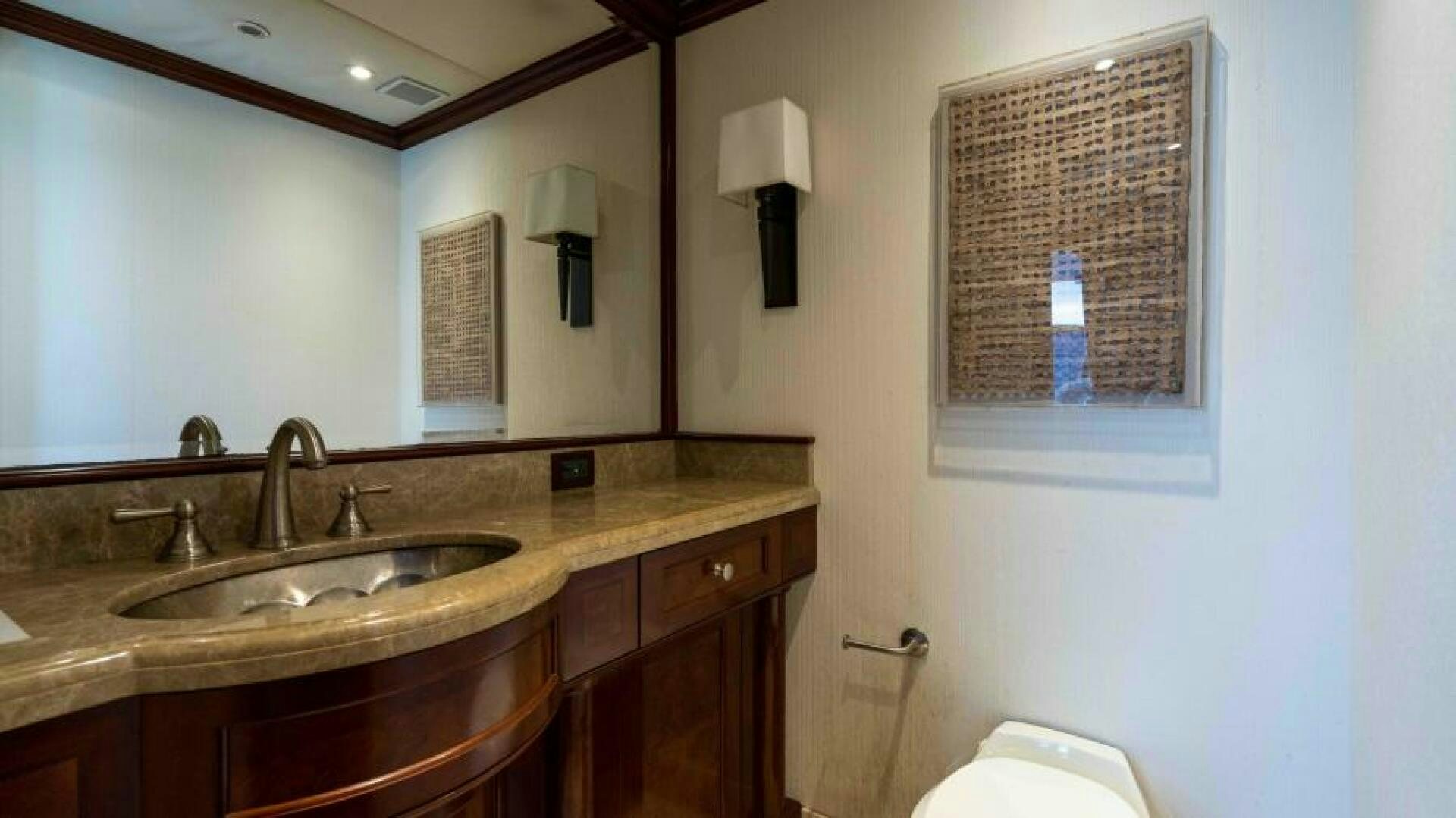 a bathroom with a sink and a mirror aboard ODIN Yacht for Sale