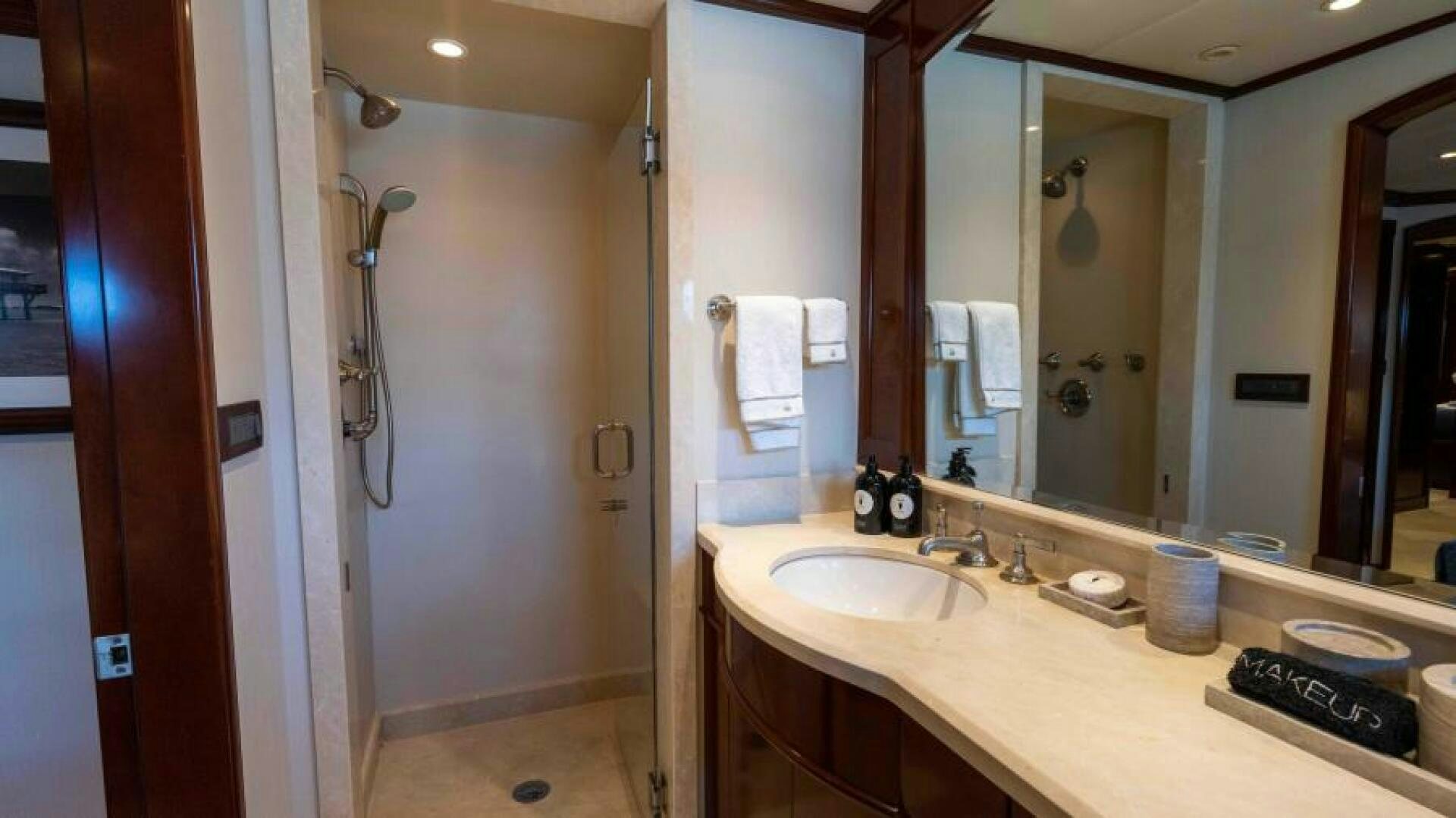 a bathroom with a countertop sink and mirror aboard ODIN Yacht for Sale