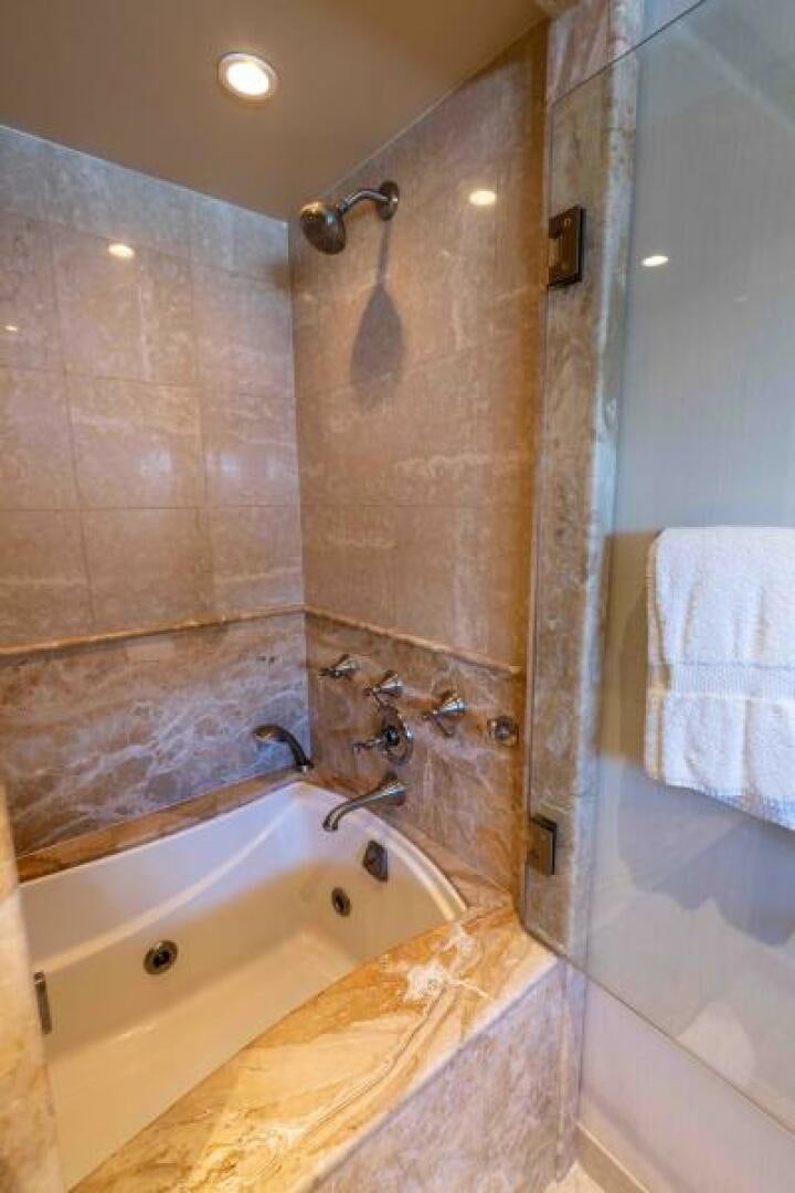 a bathroom with a bathtub and sink aboard ODIN Yacht for Sale