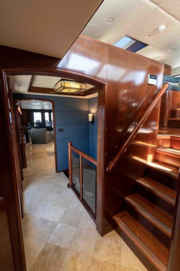 a hallway with a wood door and a blue door aboard ODIN Yacht for Sale