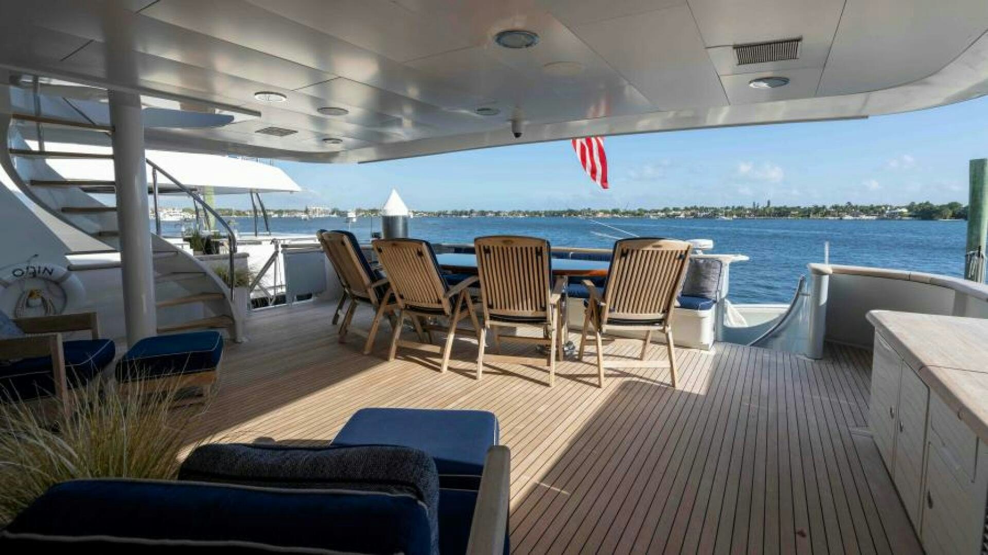 a deck with chairs and tables aboard ODIN Yacht for Sale