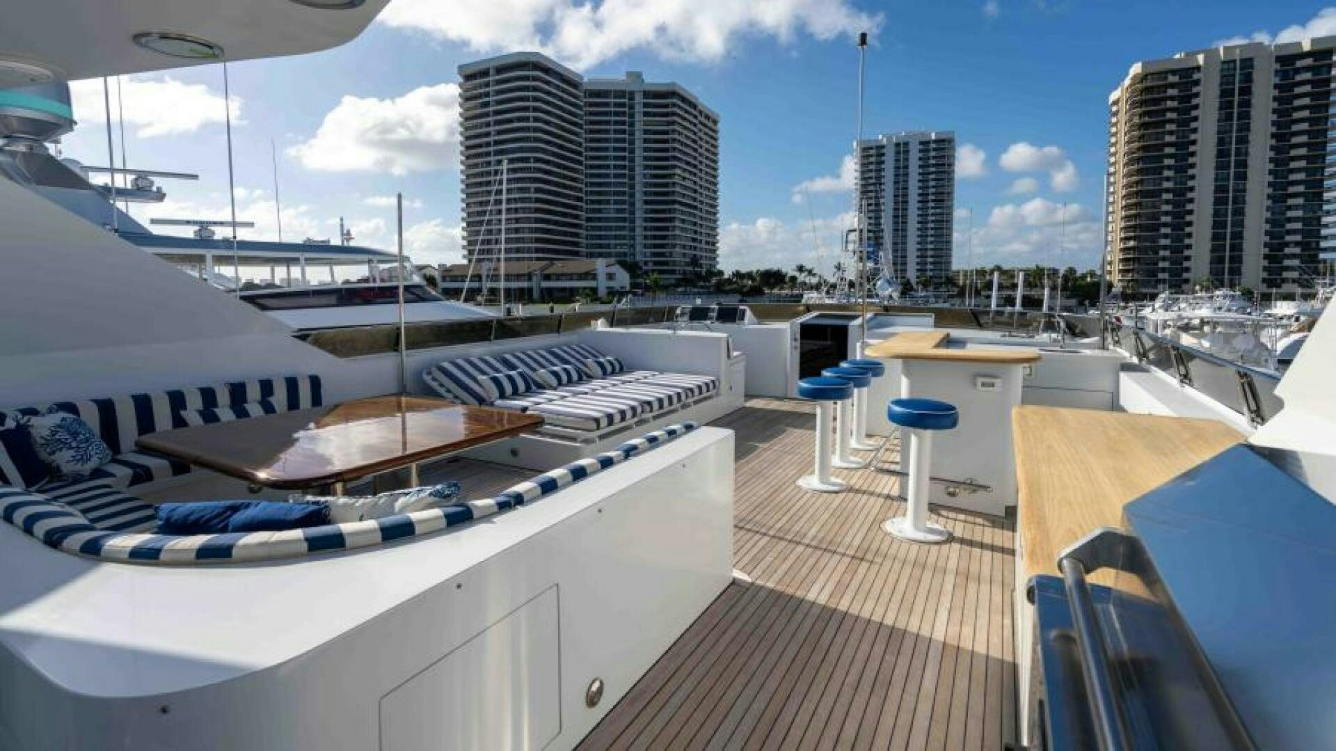 a deck with a large deck and a large building with many windows aboard ODIN Yacht for Sale