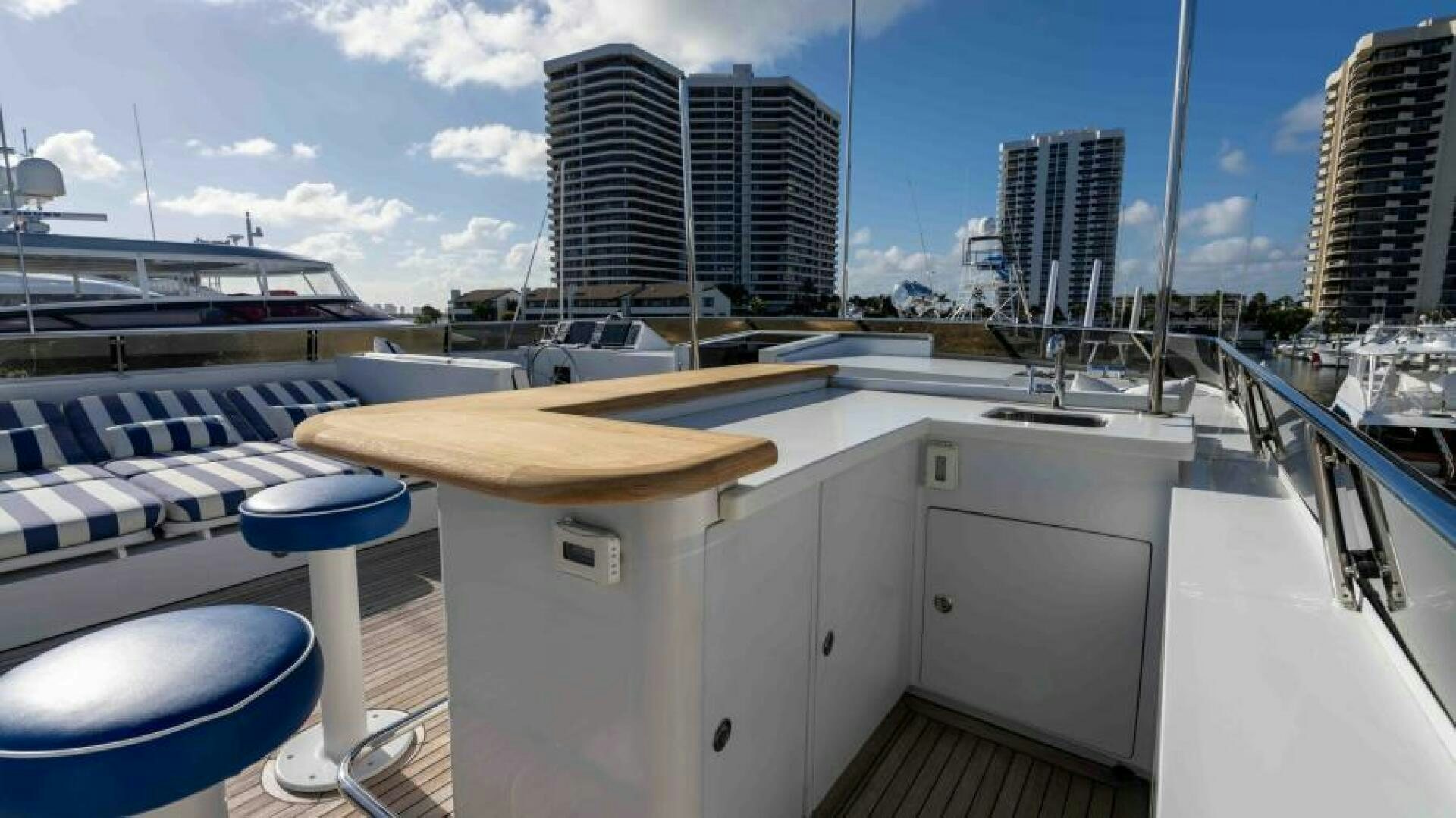 a deck with a table and chairs aboard ODIN Yacht for Sale