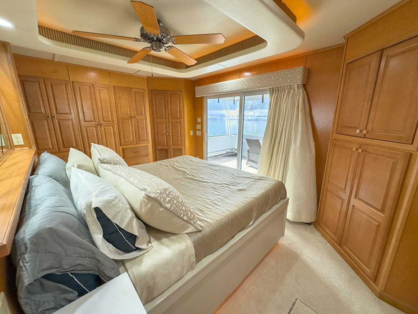 a bedroom with a bed and a ceiling fan aboard SUNSTAR Yacht for Sale