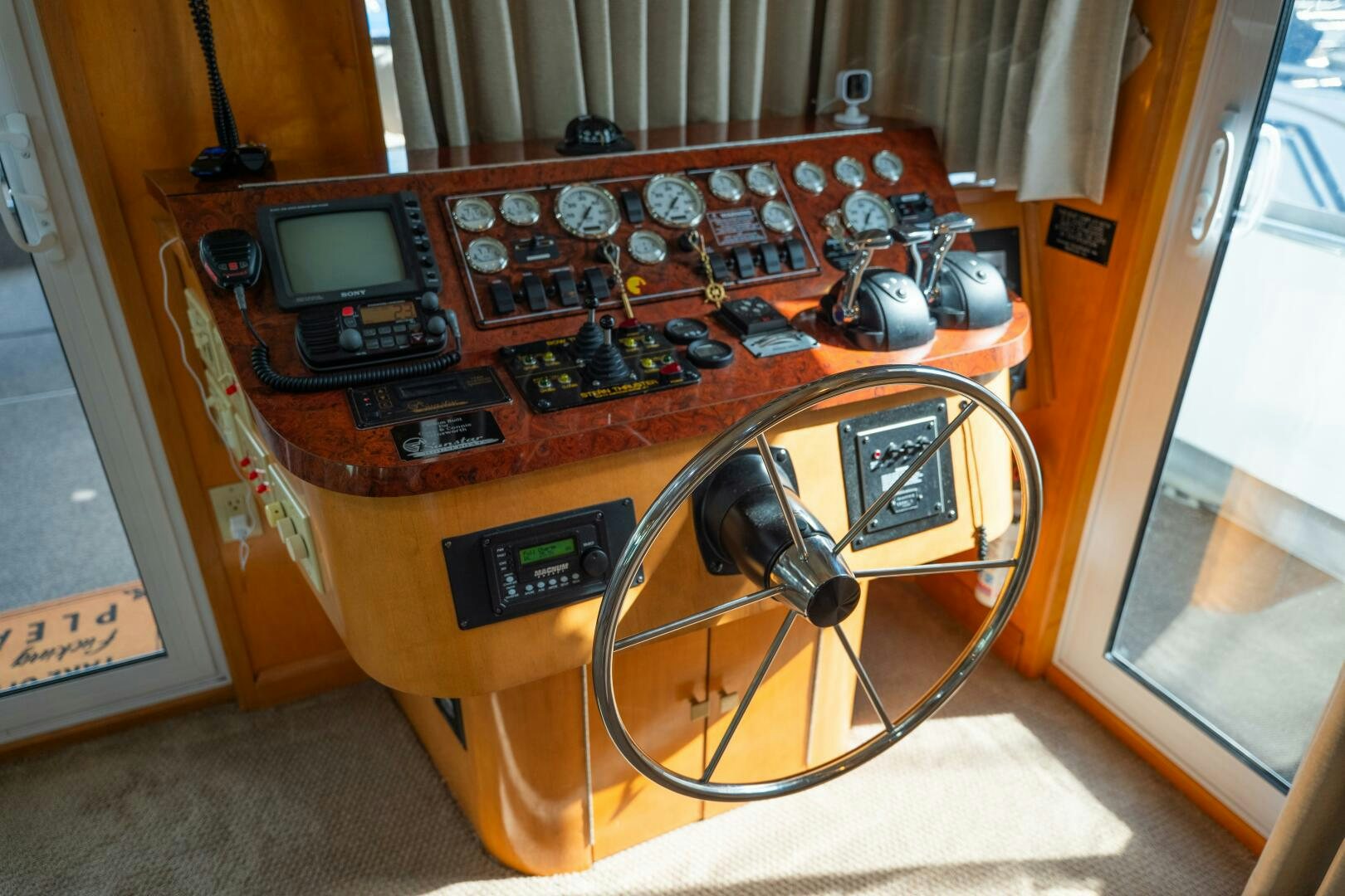 a wooden desk with a fan and a computer on it aboard SUNSTAR Yacht for Sale