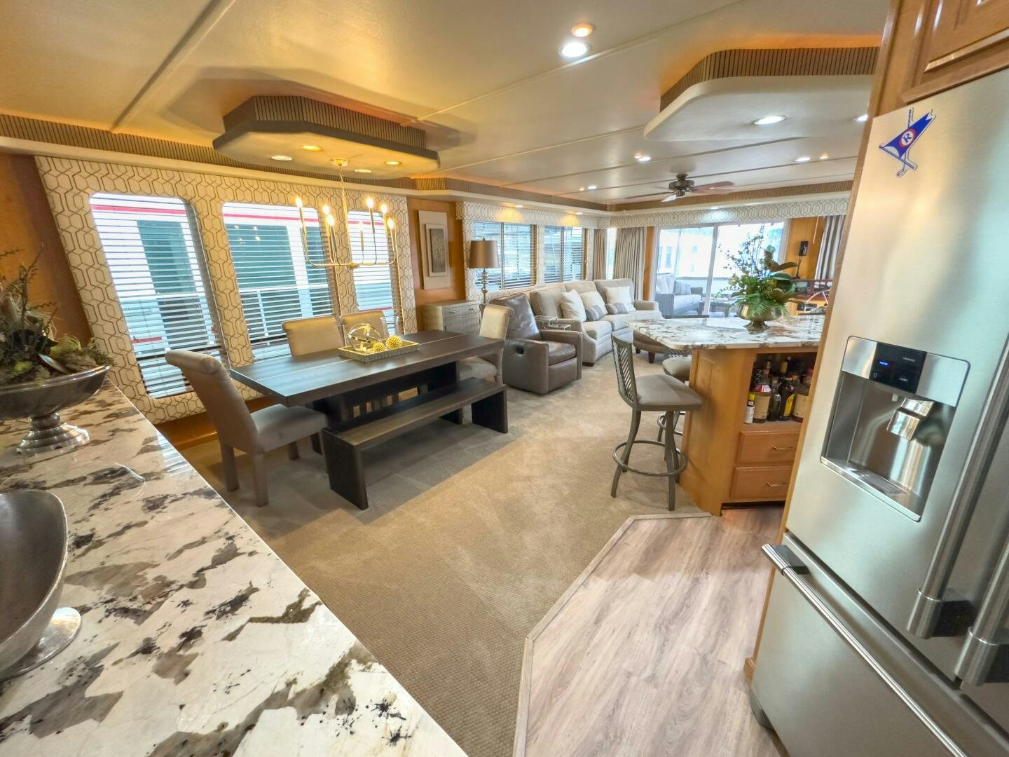 a living room with a kitchen and dining area aboard SUNSTAR Yacht for Sale