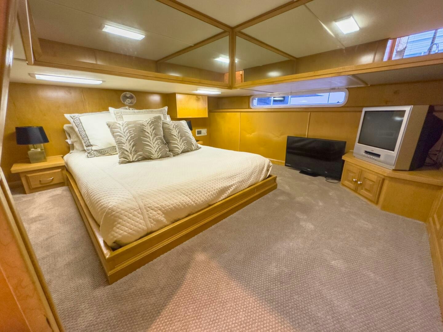 a bedroom with a bed and a tv aboard SUNSTAR Yacht for Sale