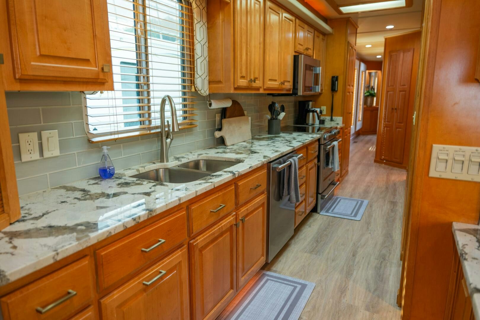 a kitchen with wooden cabinets aboard SUNSTAR Yacht for Sale