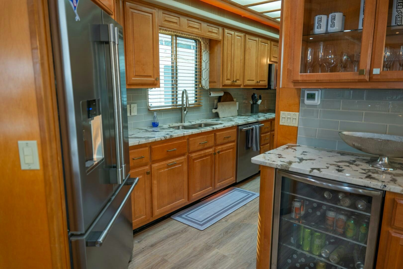 a kitchen with a stainless steel refrigerator aboard SUNSTAR Yacht for Sale