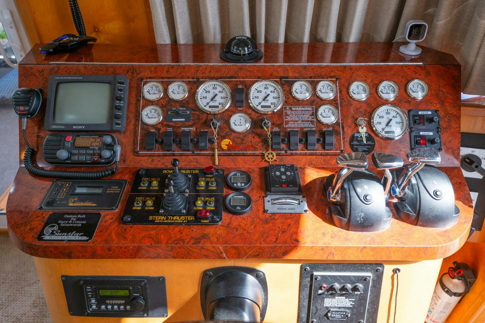 a wooden table with electronic devices aboard SUNSTAR Yacht for Sale