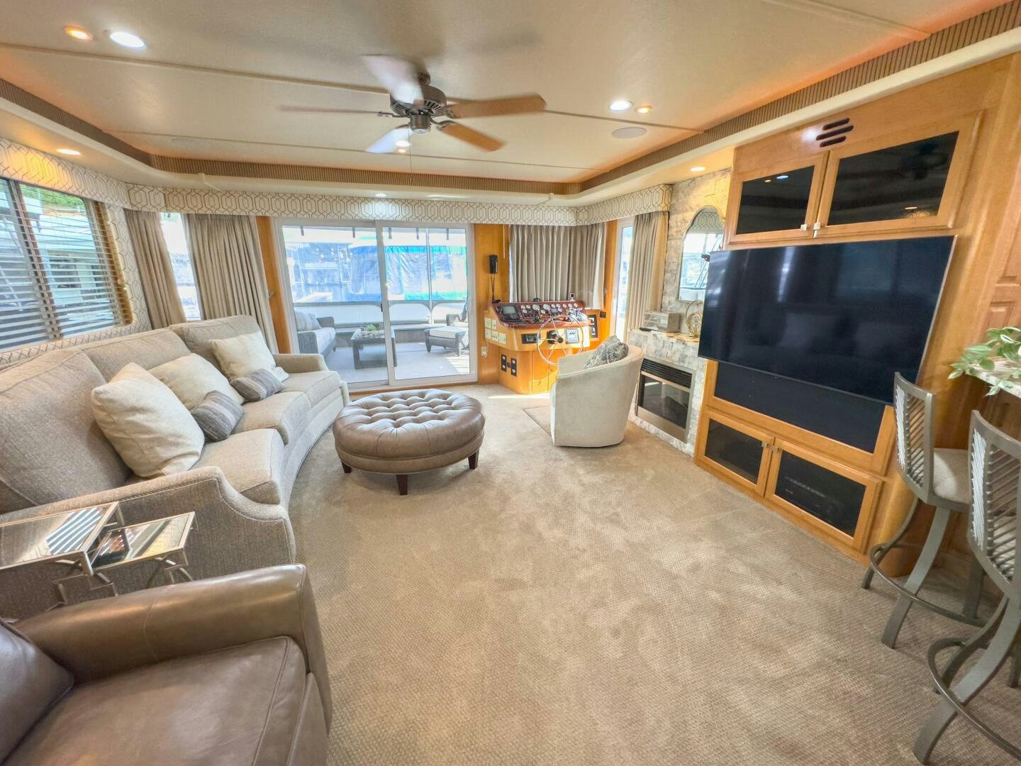 a living room with a tv and furniture aboard SUNSTAR Yacht for Sale