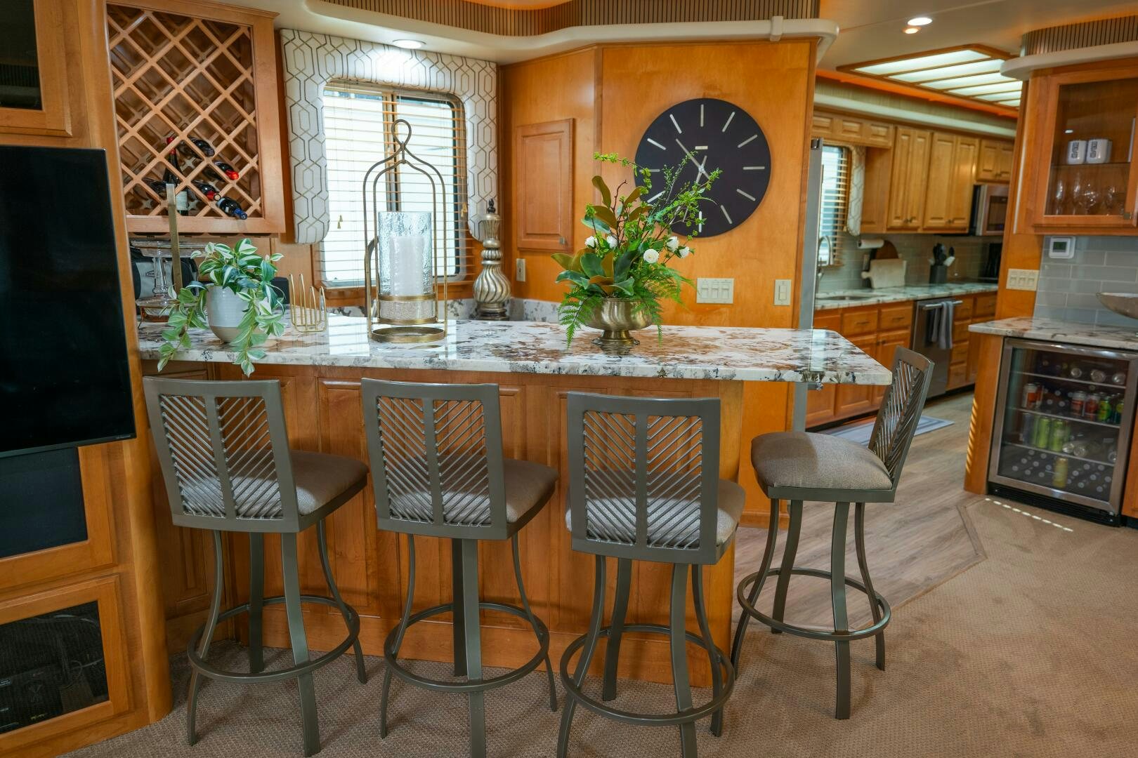 a kitchen with a bar and stools aboard SUNSTAR Yacht for Sale