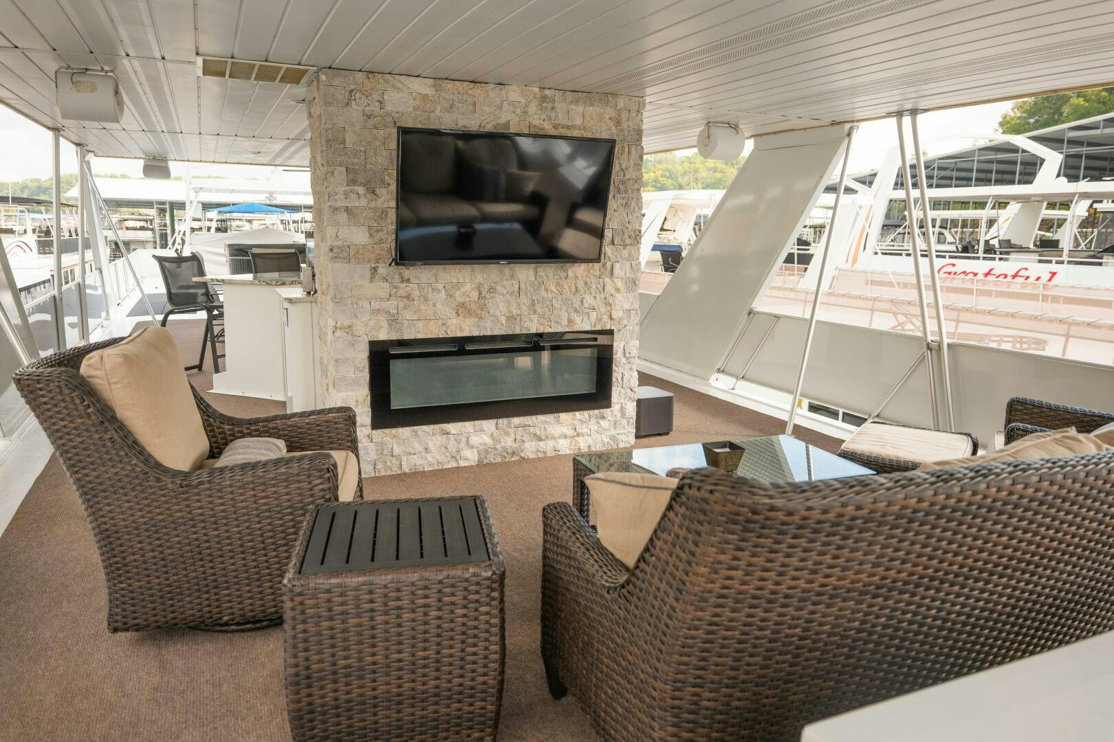 a living room with couches and a fireplace aboard SUNSTAR Yacht for Sale