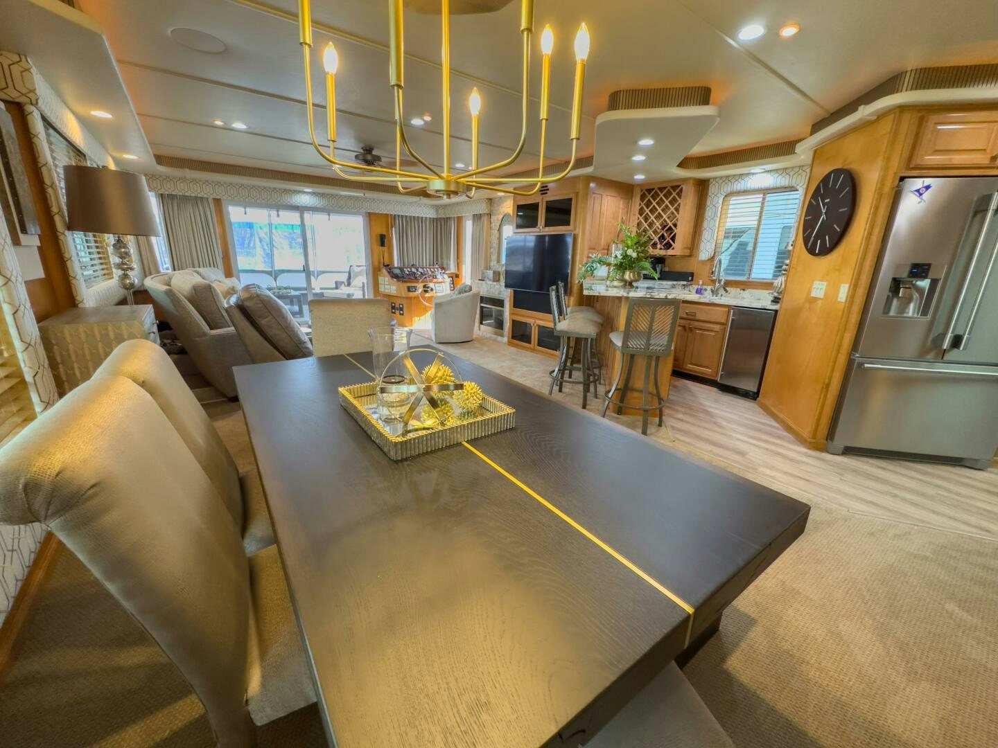 a large living room with a bar and a table aboard SUNSTAR Yacht for Sale