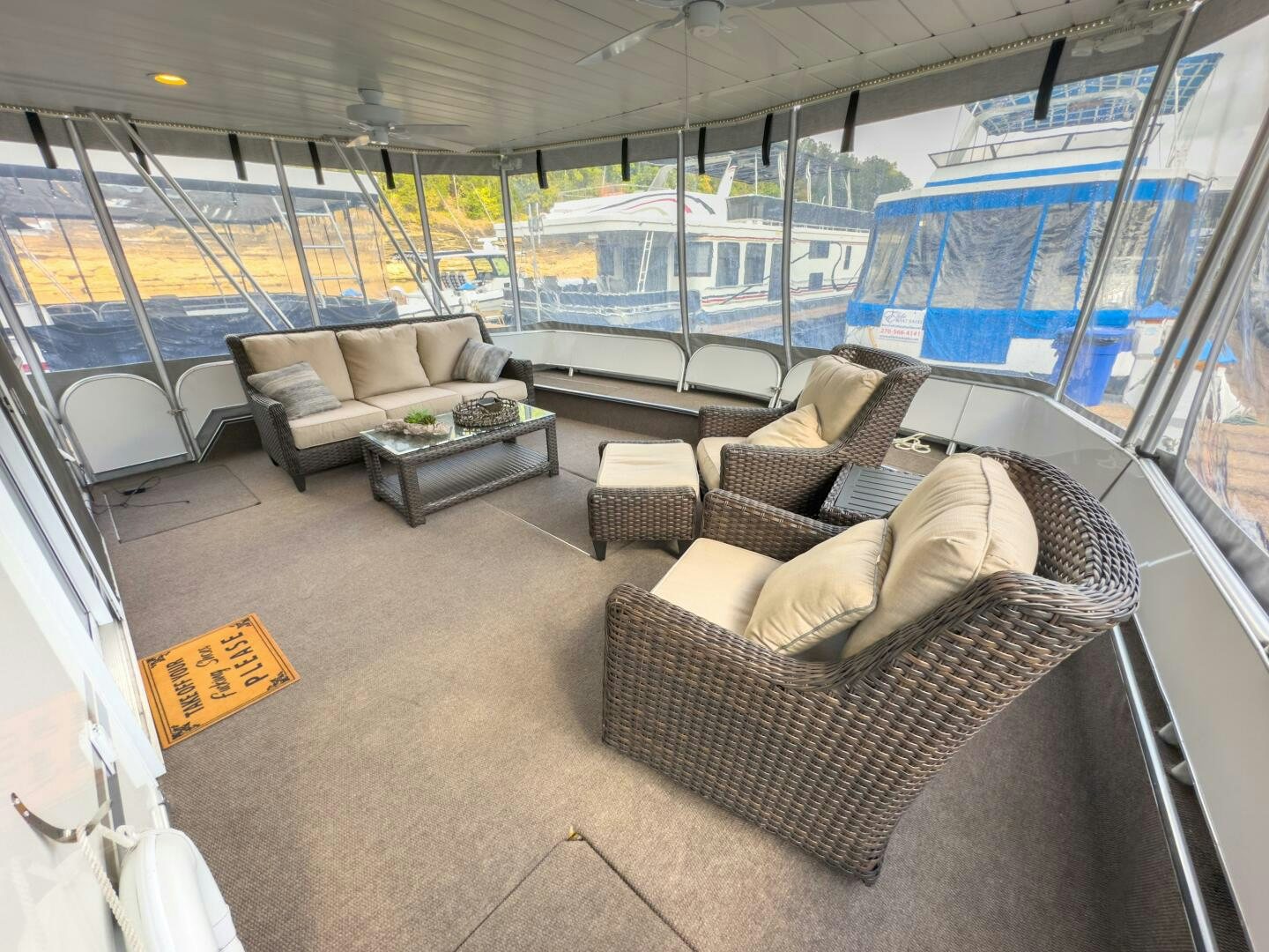 a living room with a couch and a large window aboard SUNSTAR Yacht for Sale